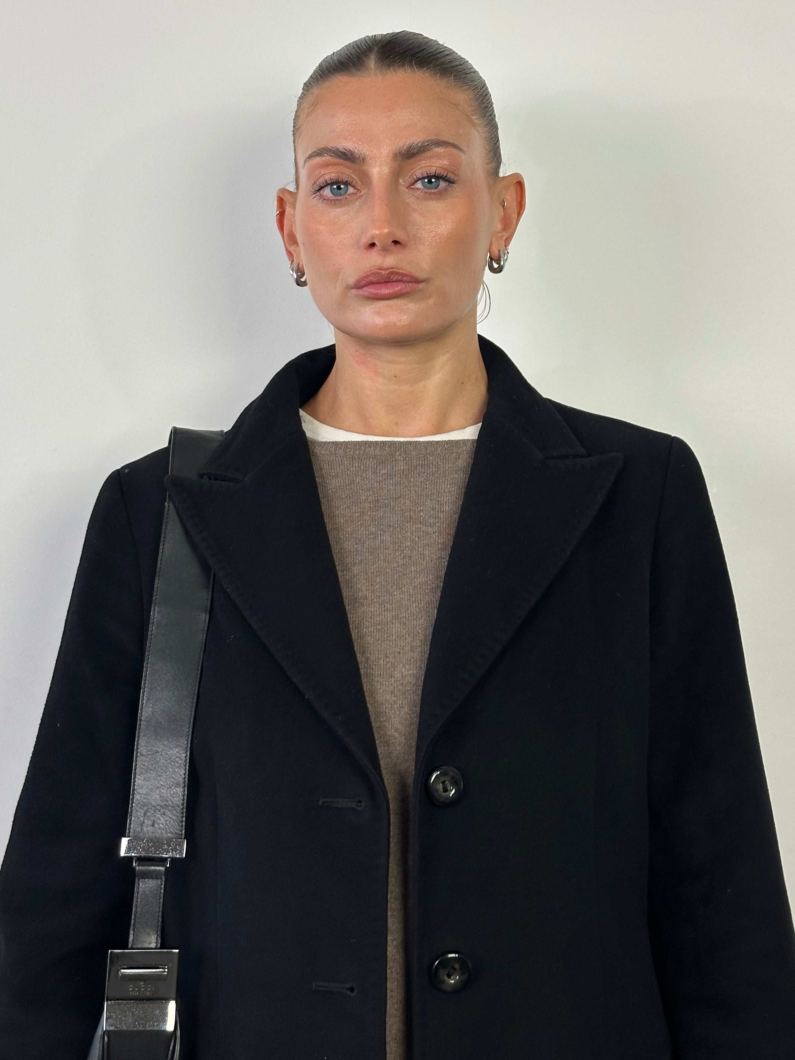 Max Mara Studio pure virgin wool single-breasted coat in black, displayed on a hanger with a classic lapel design.