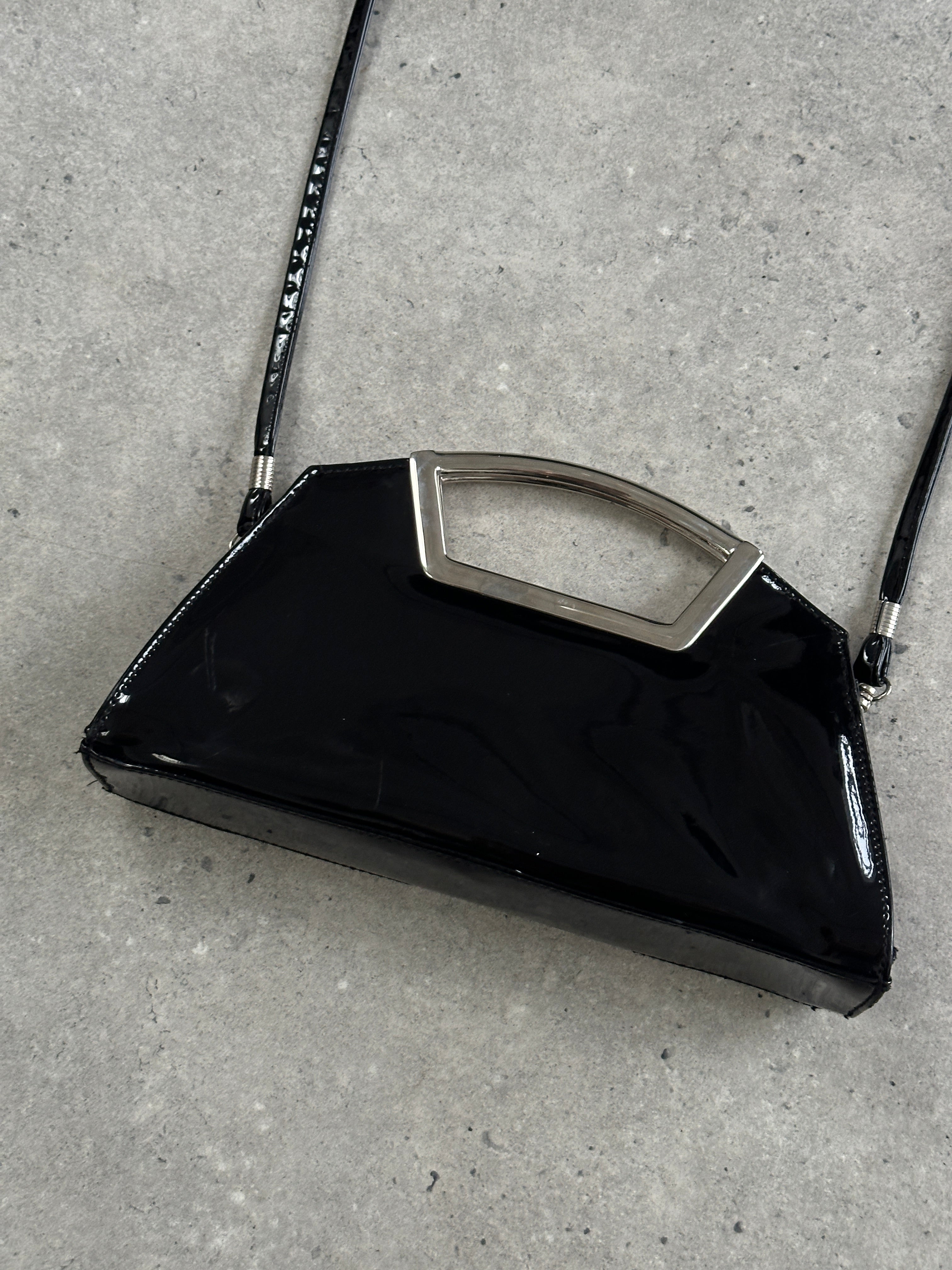Vintage 2000s patent vinyl chrome crossbody clutch bag with sleek design and shiny finish.