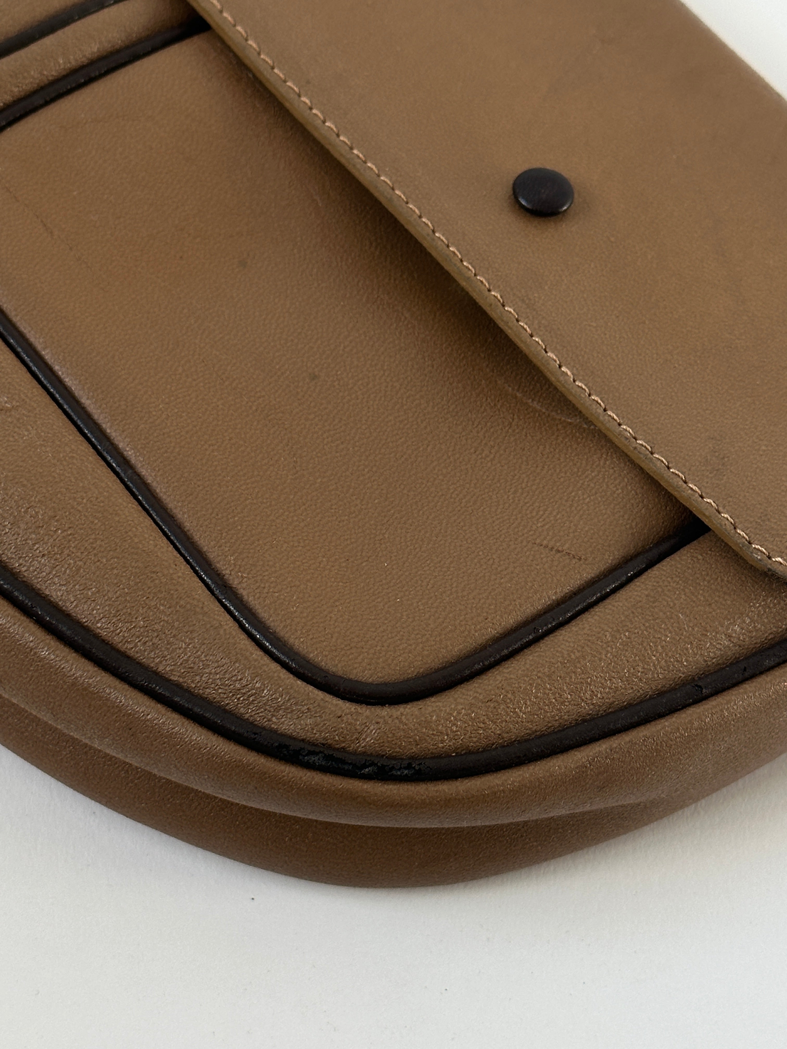 Vintage Italian leather crescent crossbody bag with adjustable strap and classic design, showcasing rich textured leather.
