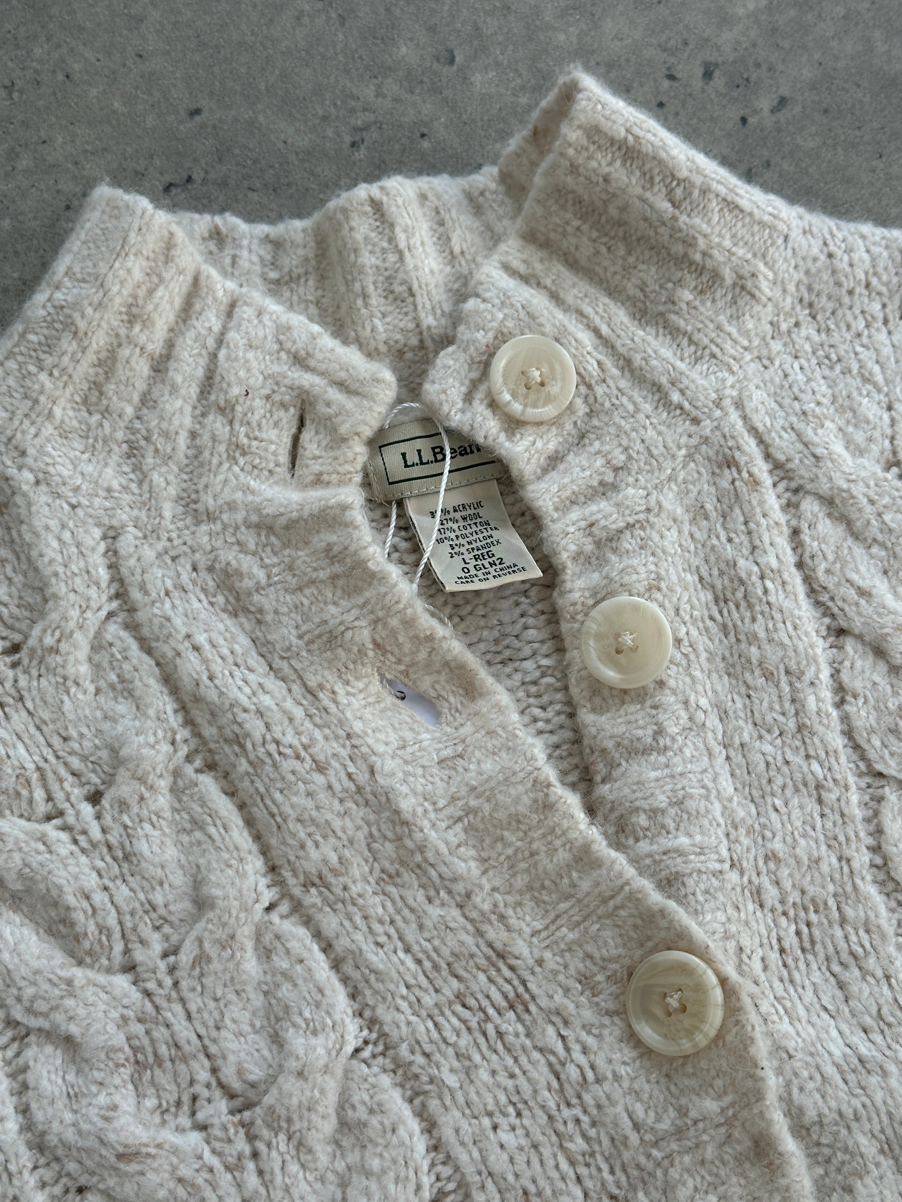 L.L. Bean wool sleeveless knitted cardigan in size large, featuring a cozy, textured knit pattern and button closure.