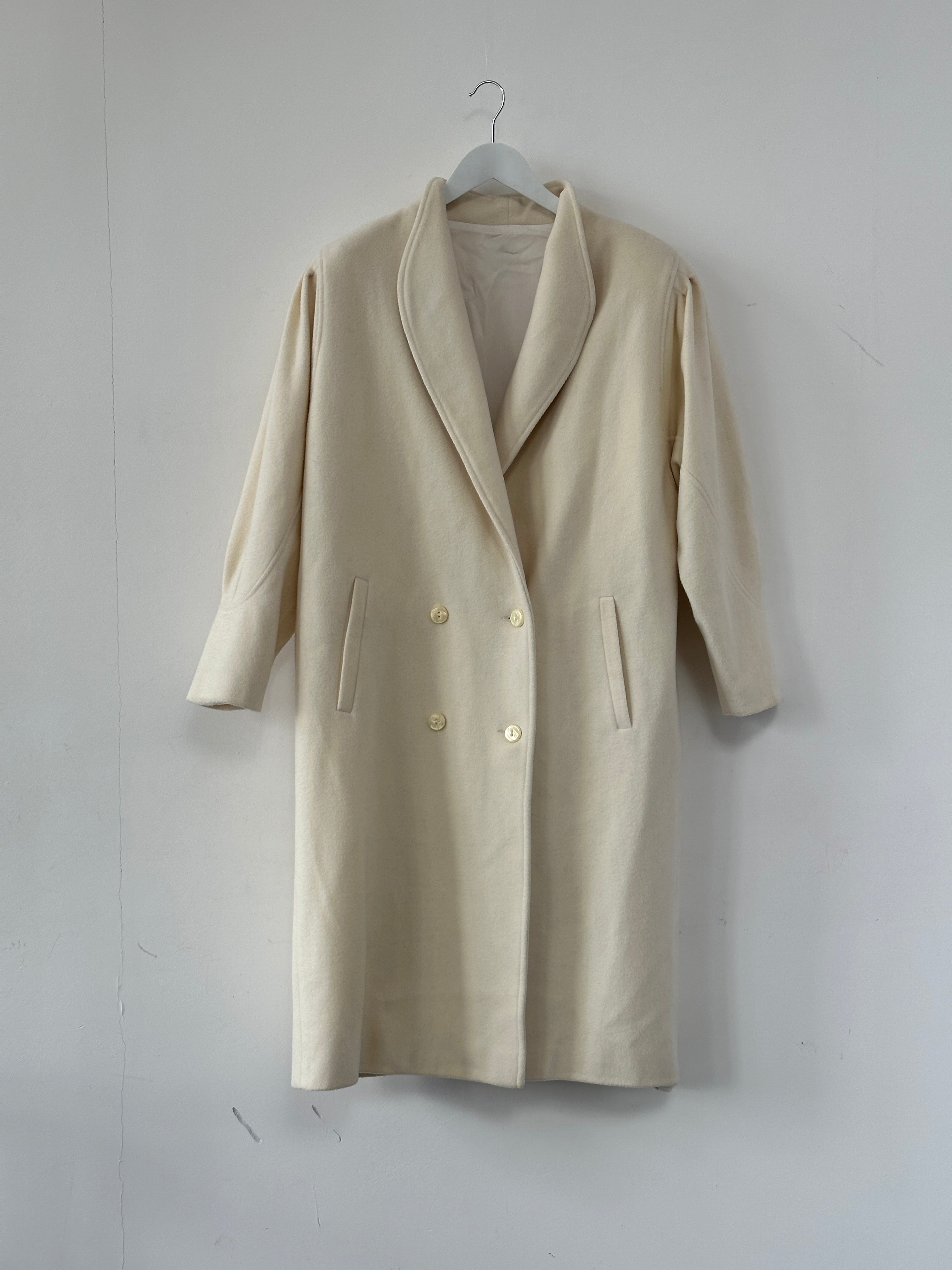 Vintage pure wool double-breasted coat in size L/XL, featuring classic design and tailored fit, displayed on a hanger.