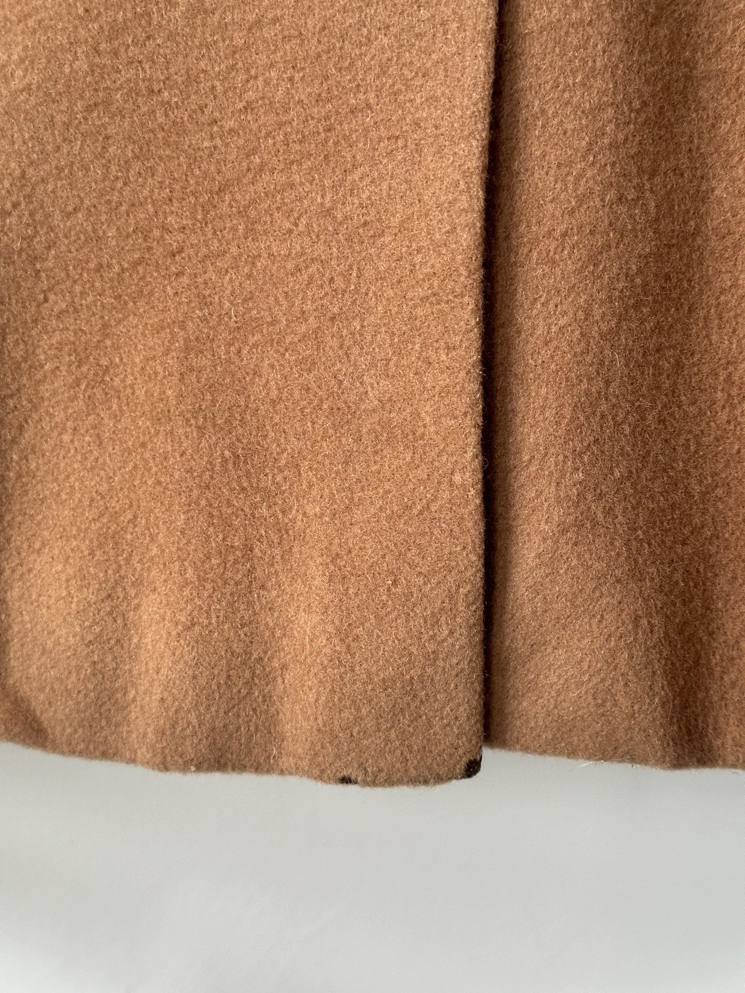 Burberry wool camel hair single-breasted coat in size L displayed on a hanger, showcasing classic design and luxurious fabric.