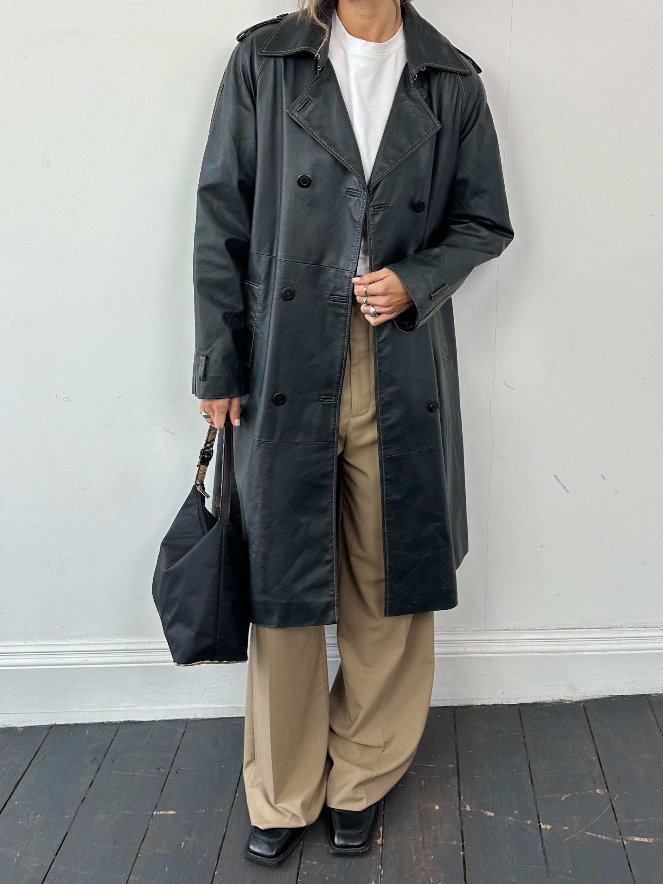 Conbipel contrast stitch double-breasted leather trench coat in black, featuring a classic design and stylish lapel collar.