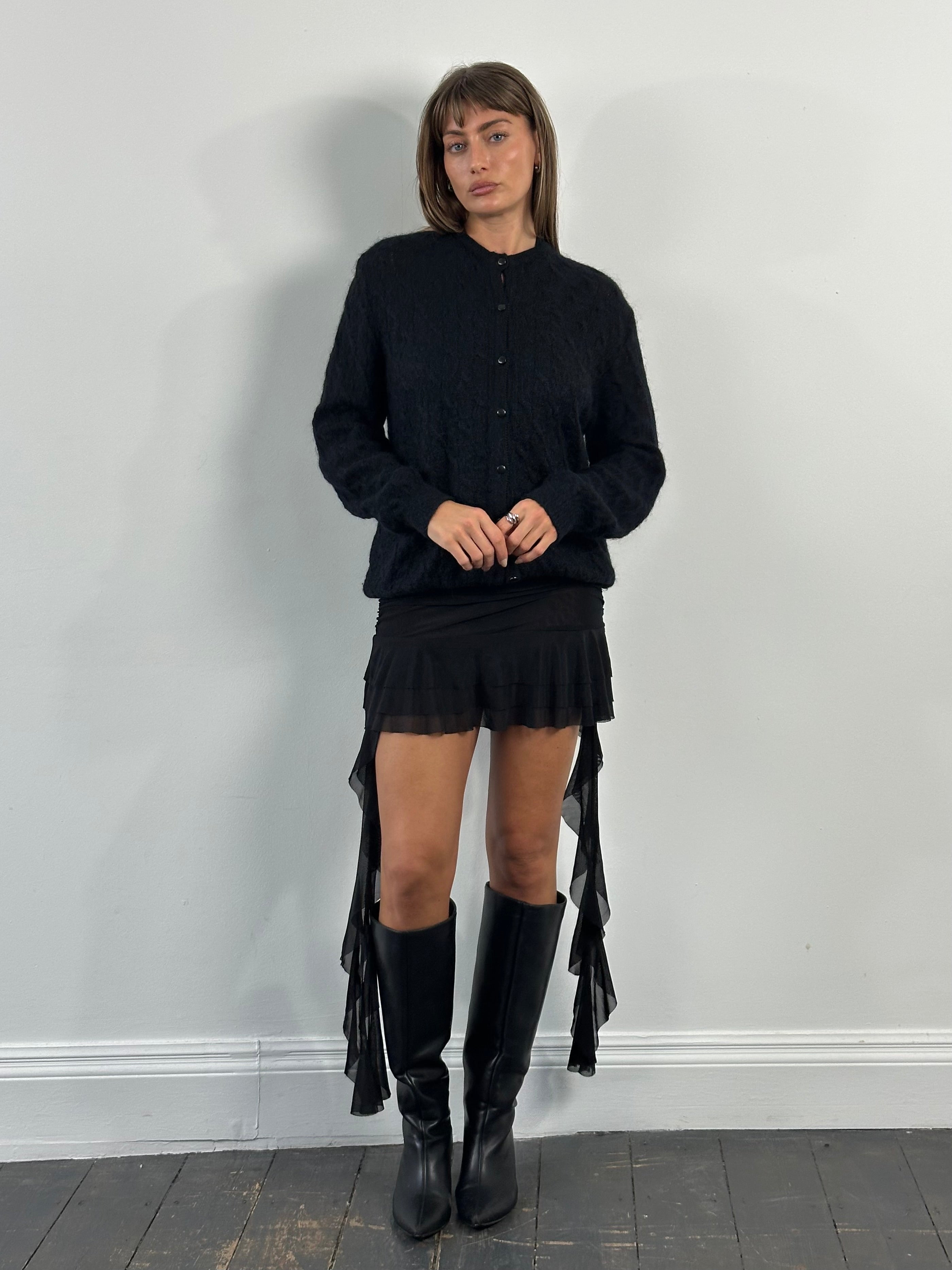 Vintage 1990s layered ruffle mini skirt in size S, showcasing its playful, textured fabric and retro style.