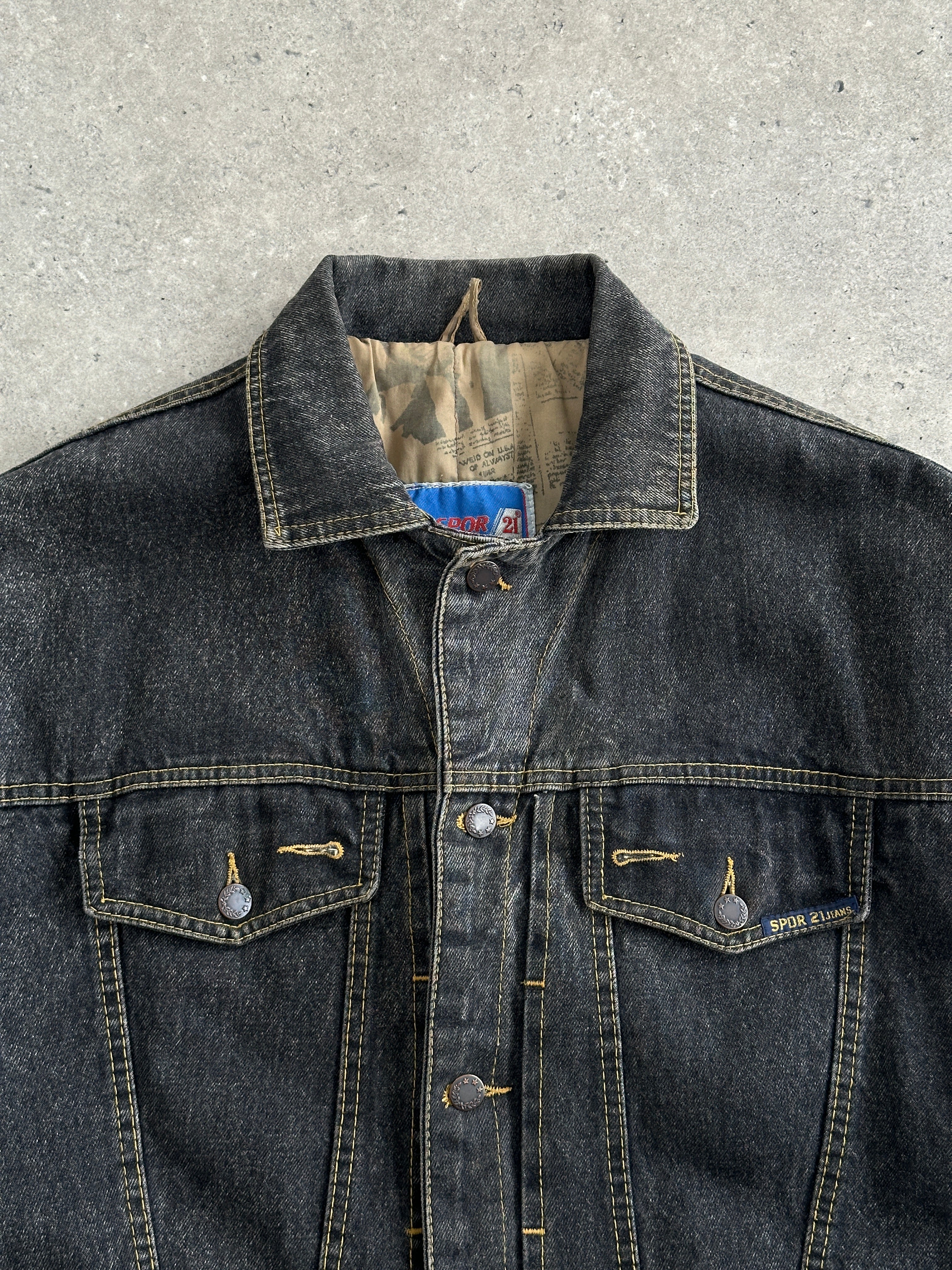 Vintage 1990s boxy denim jacket in medium size, featuring classic blue denim and a relaxed fit, styled with front pockets and button closure.