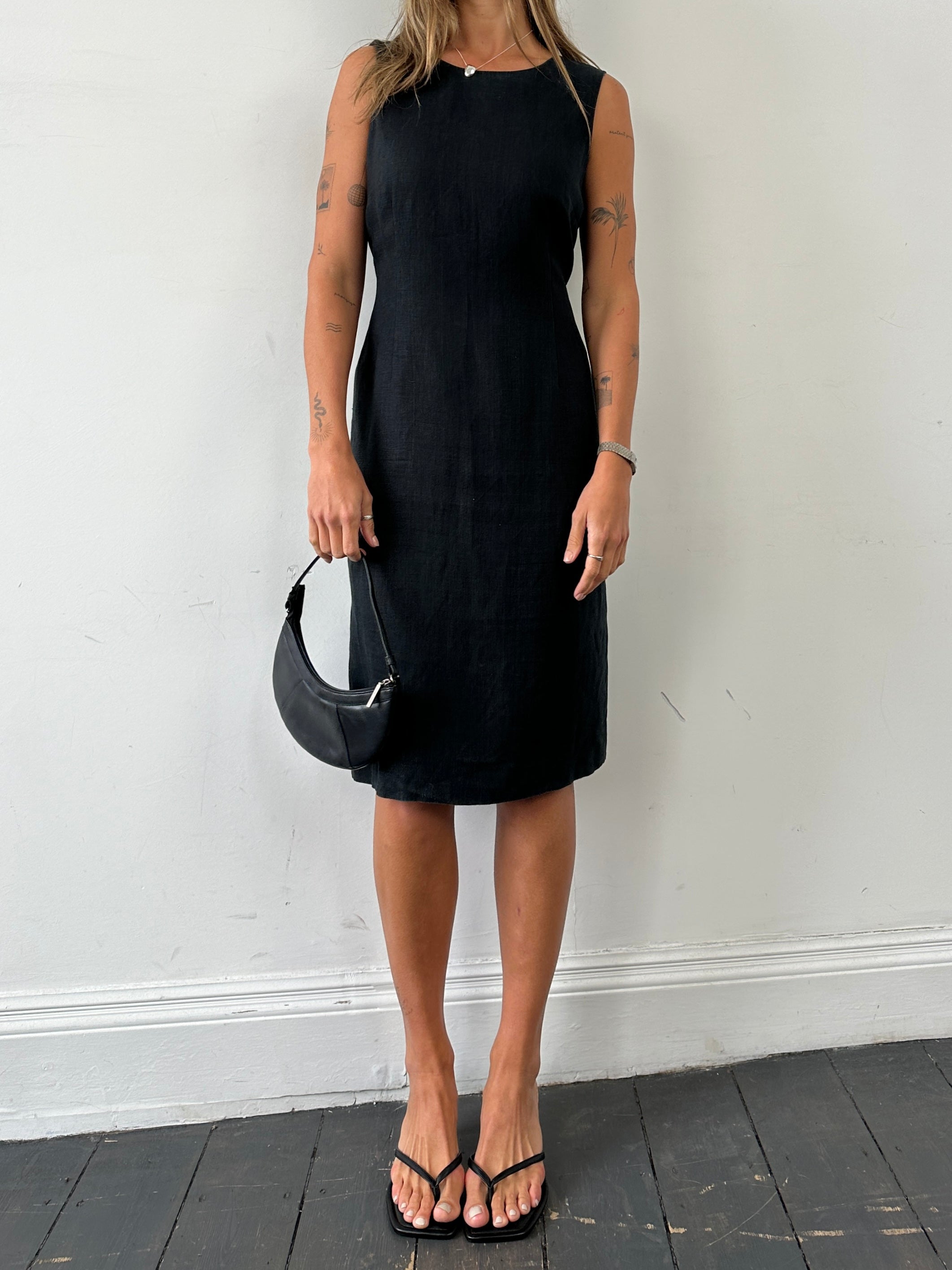 Jaeger pure linen midi sleeveless dress in size M/L displayed on a hanger, showcasing its lightweight fabric and elegant design.