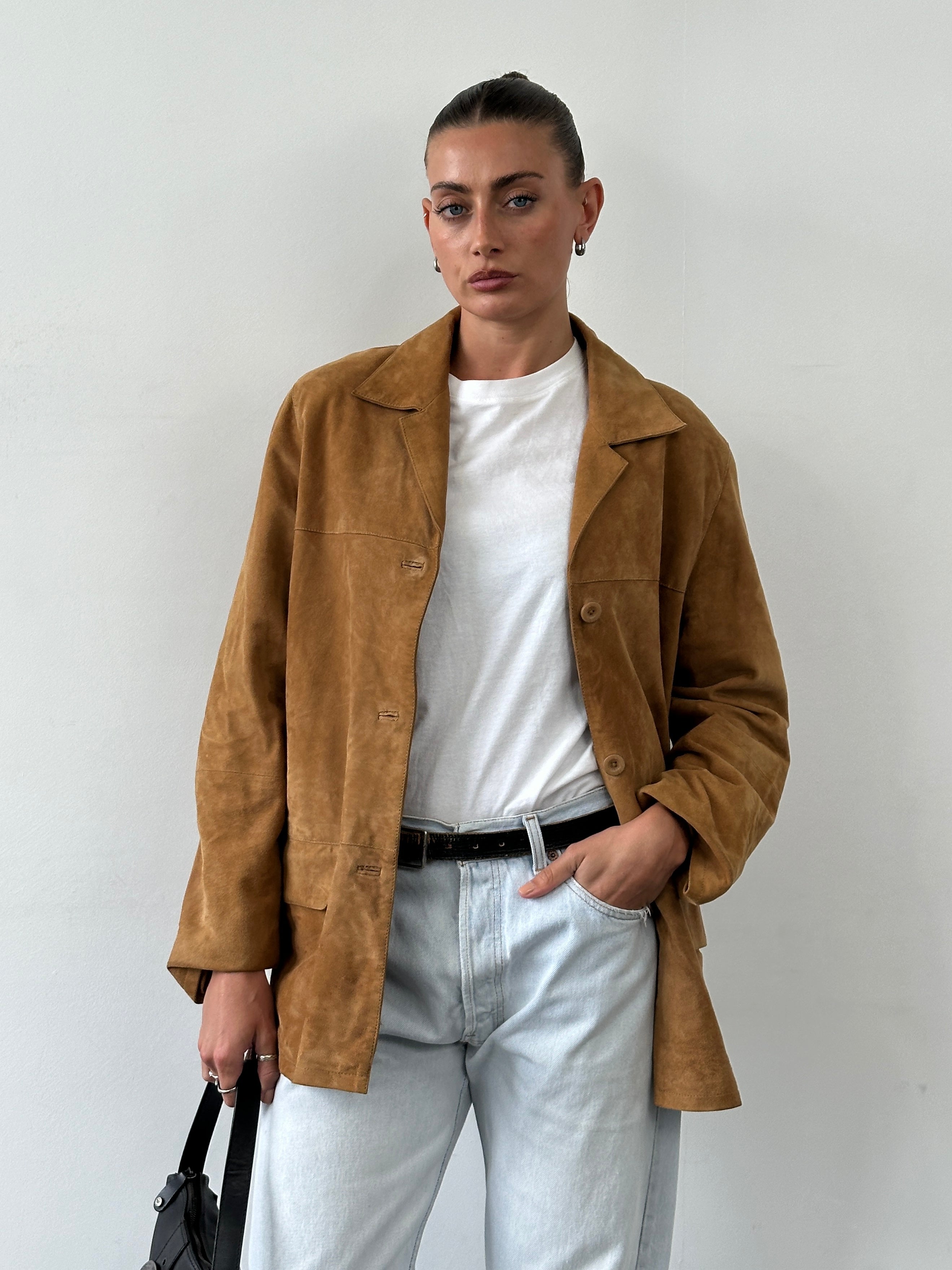 Vintage leather suede jacket in M/L size, featuring classic style and textured material, displayed on a hanger.