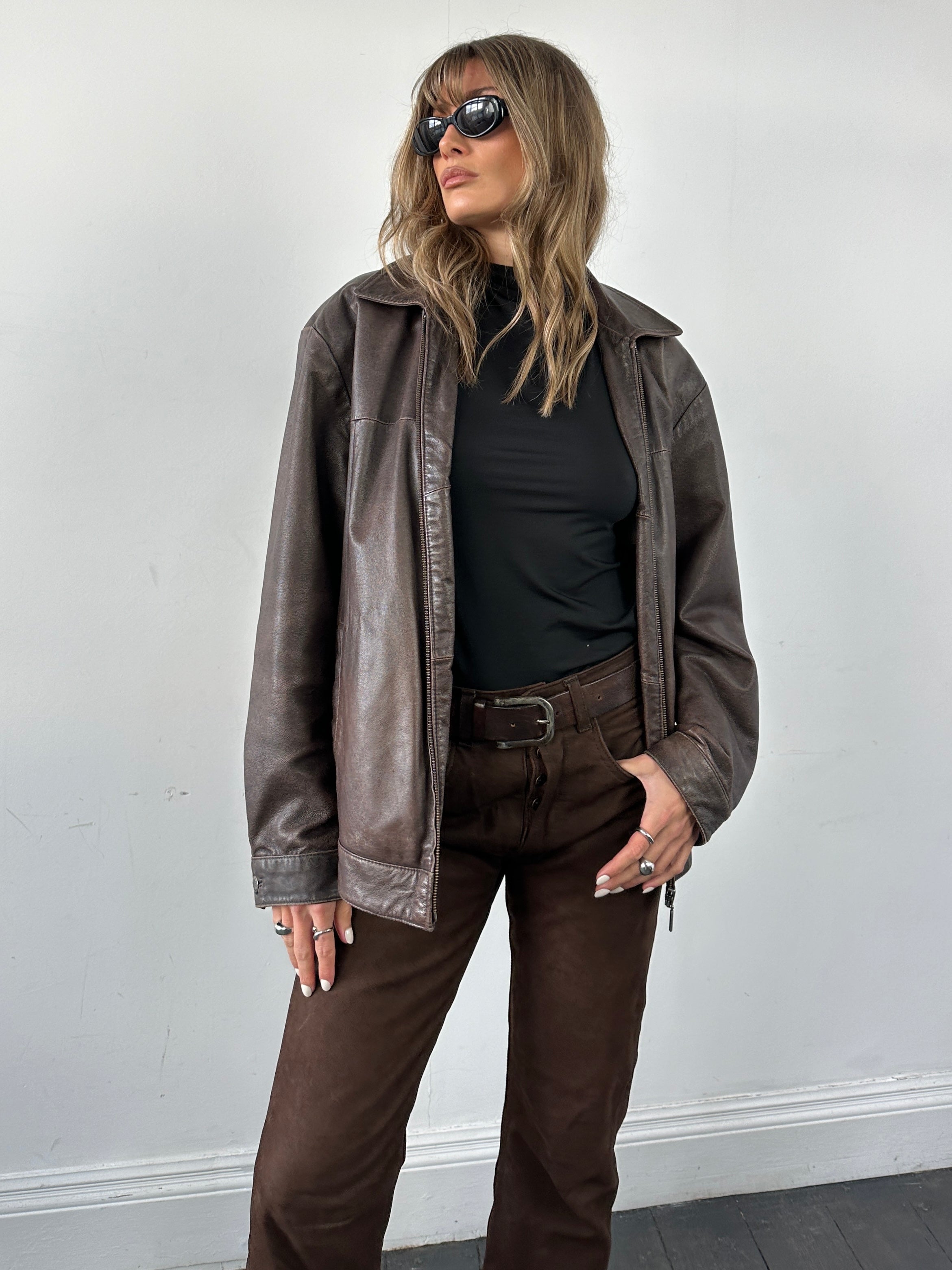 Vintage distressed leather jacket in M/L size, featuring a rugged, worn-in look and classic design, by Vintage.
