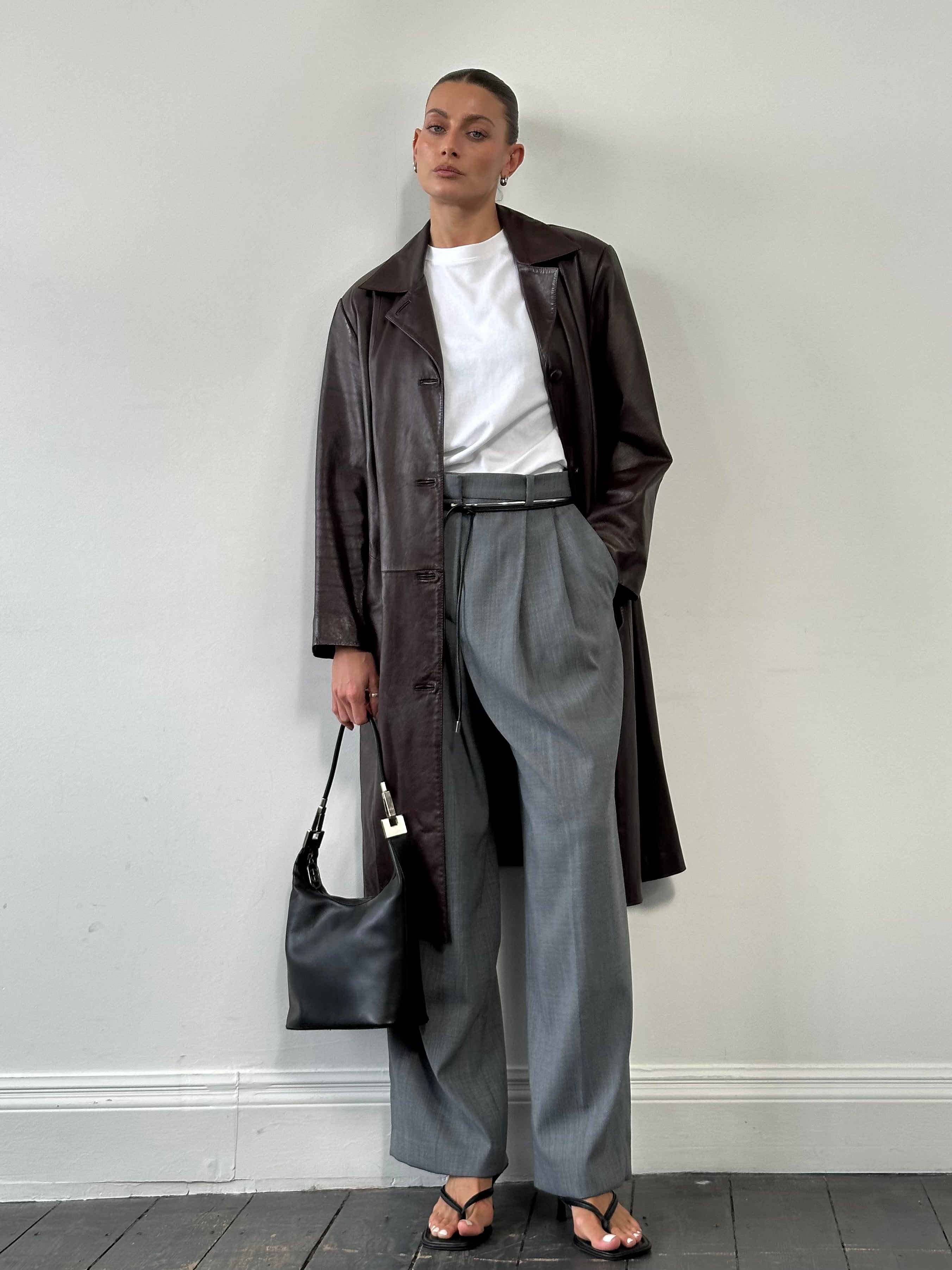Vintage leather trench coat jacket in size large, classic design with a timeless, distressed leather finish and tailored fit.