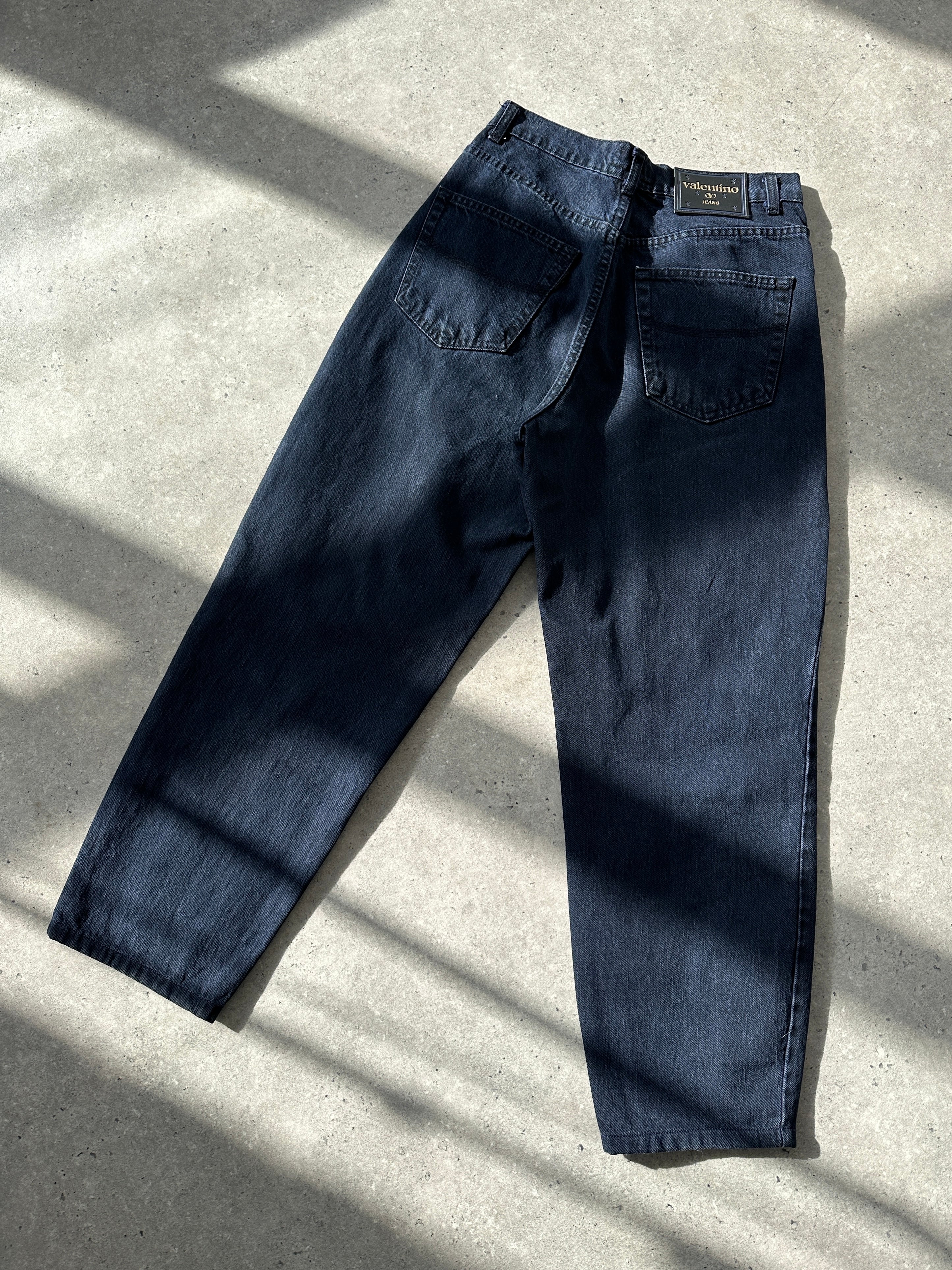 Valentino tapered high-waisted denim jeans in W28 with classic five-pocket design and clean blue wash.