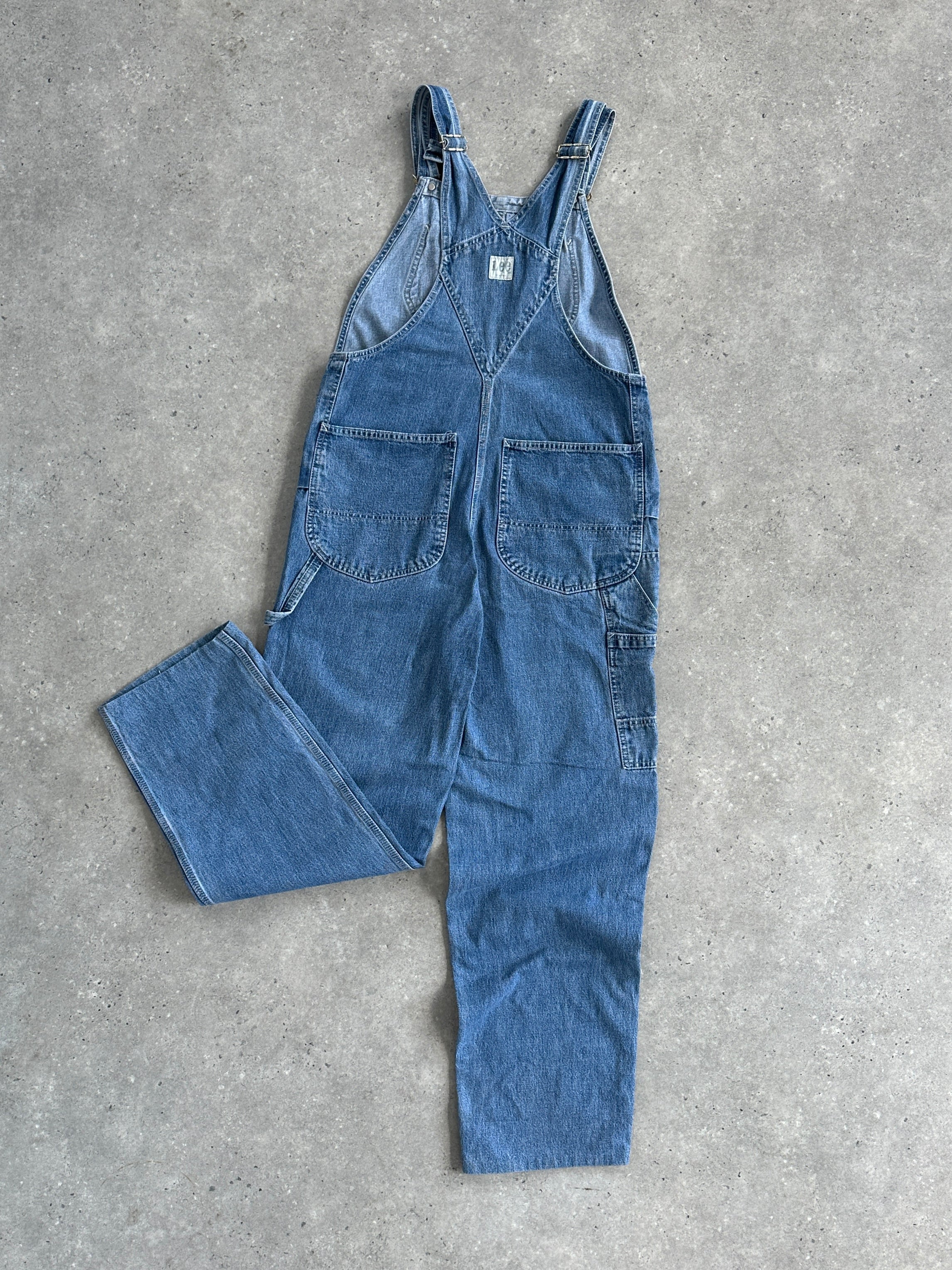 Lee Pure Cotton Denim Dungarees in size M, featuring classic blue denim fabric with adjustable shoulder straps and front pockets.