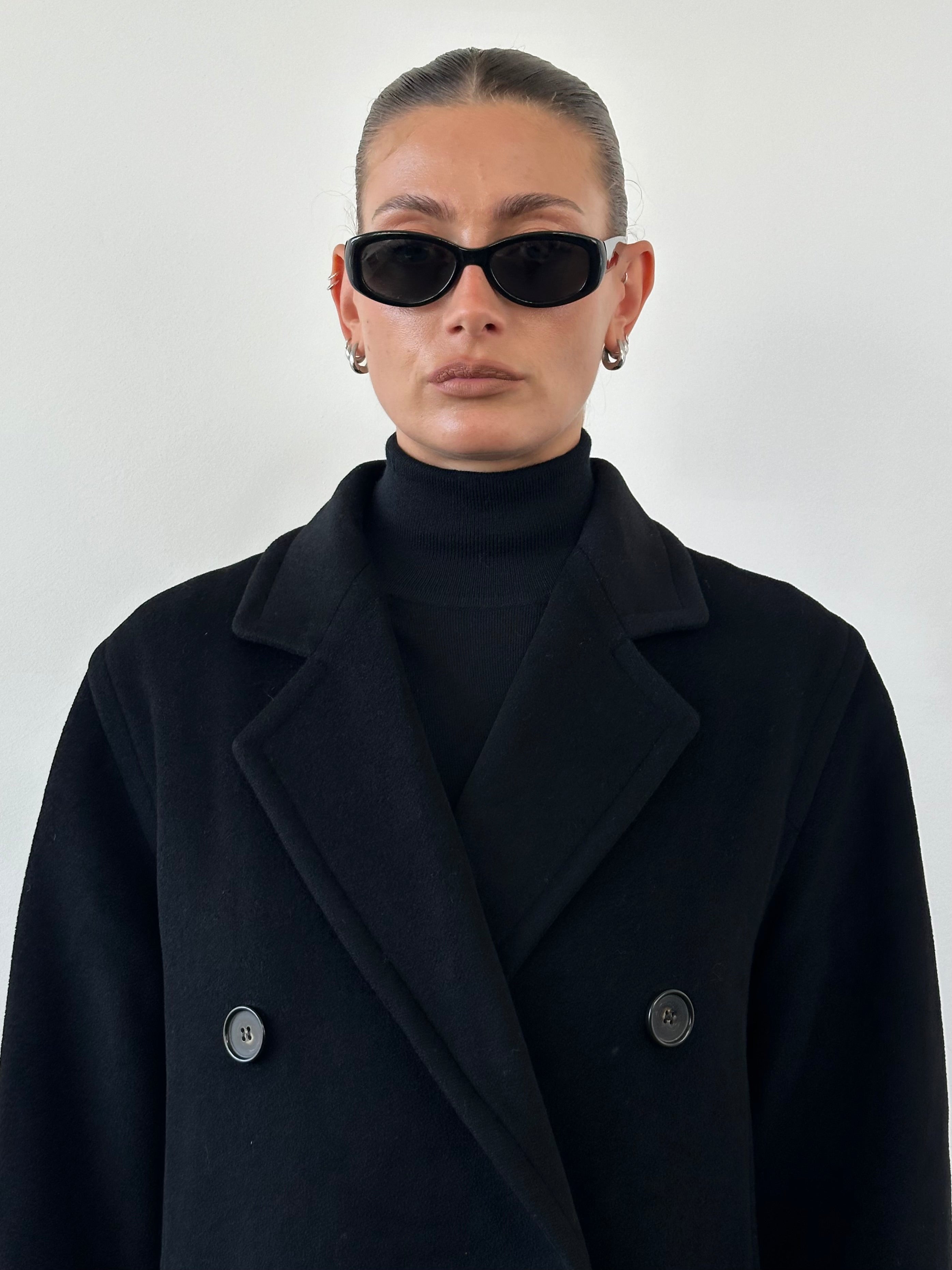Vintage wool and cashmere double-breasted coat in M/L size with classic design, shown on a hanger against a neutral background.
