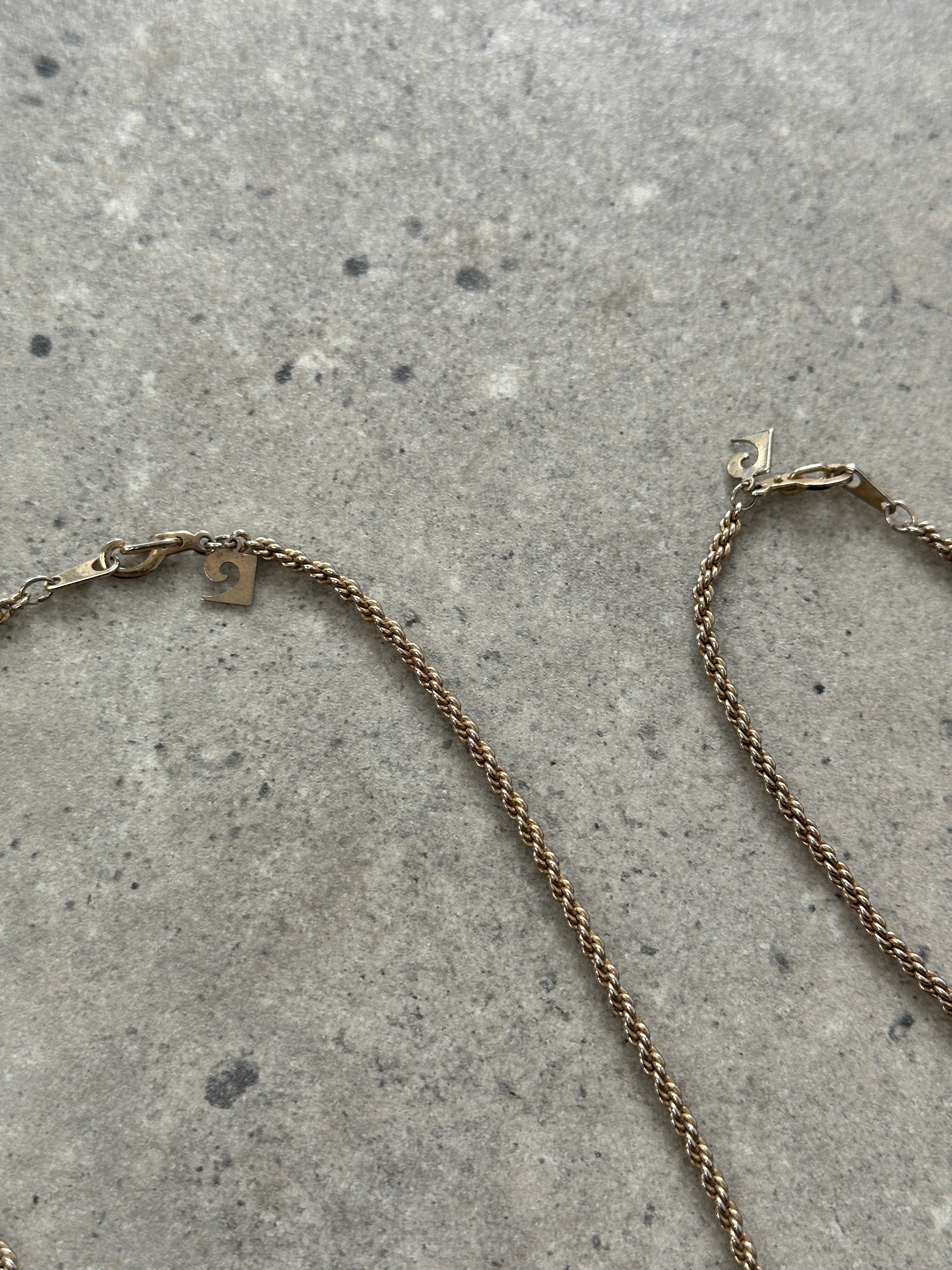 Pierre Cardin gold plated necklace and bracelet chain set, featuring elegant jewelry with shiny gold finish and classic design.