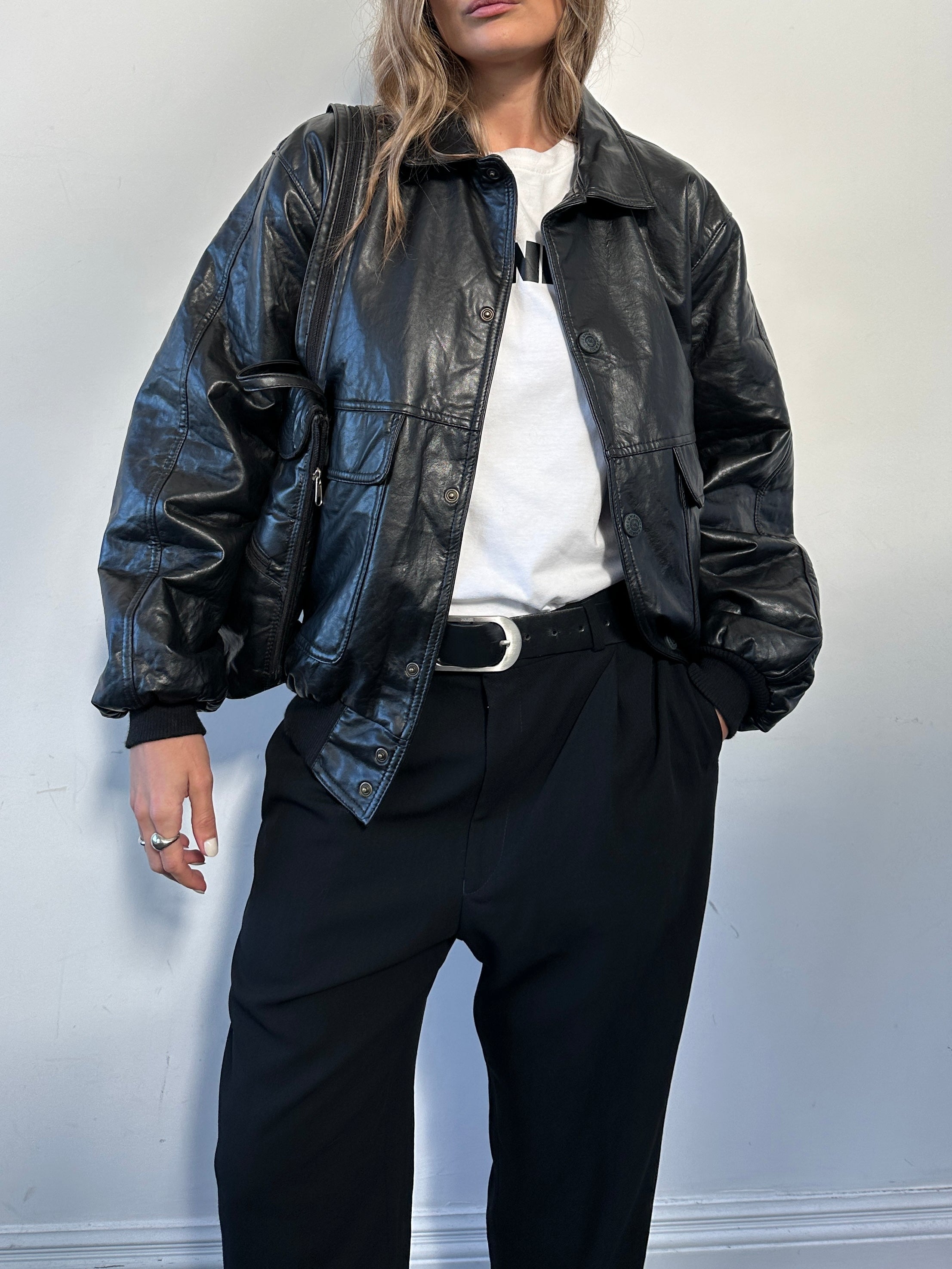 Vintage Italian faux leather bomber jacket in size L, showcasing classic design with detailed stitching and a sleek finish.