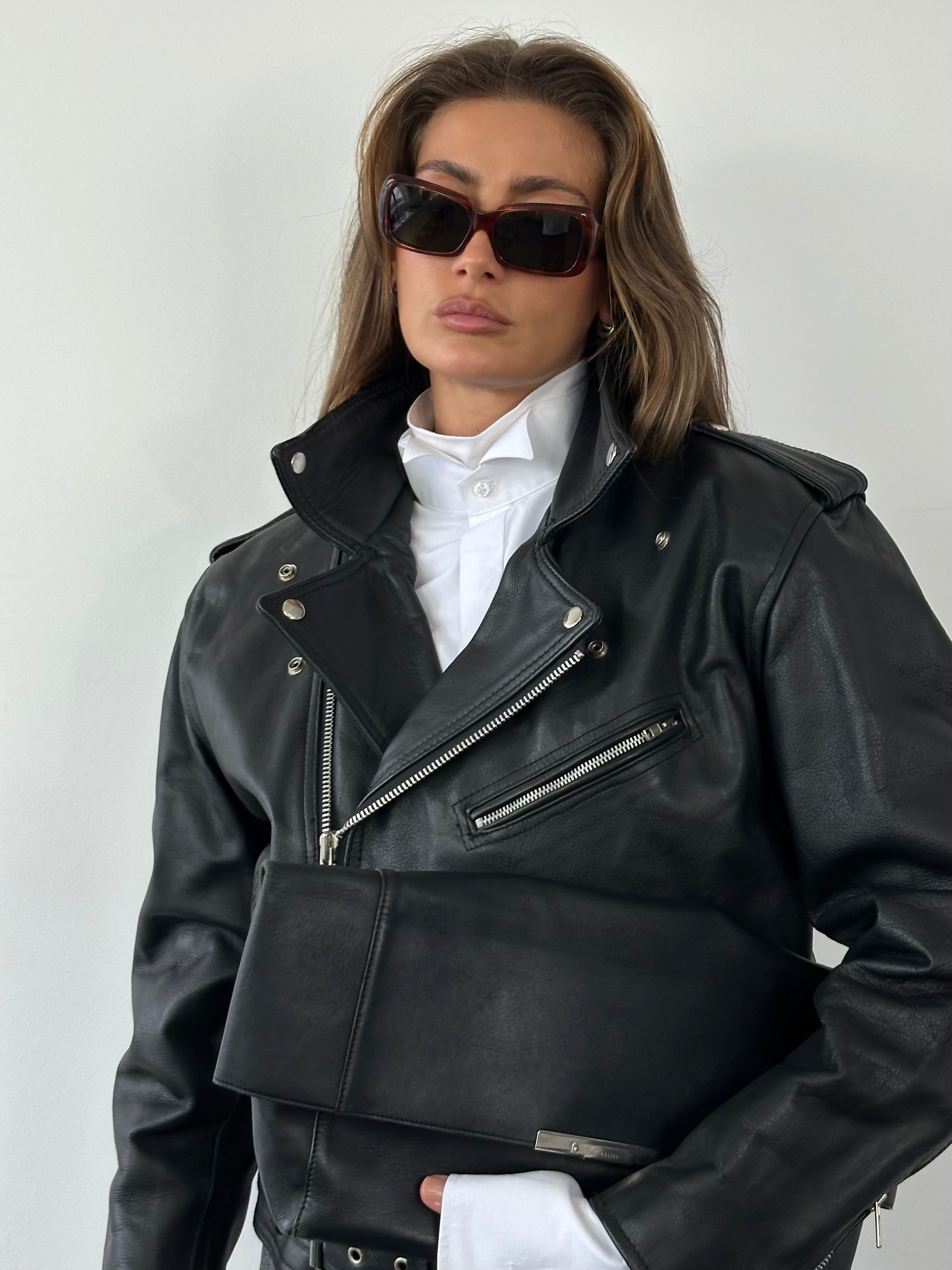 Vintage 1990s leather biker jacket in size M, featuring classic design and distressed brown leather with metal hardware details.