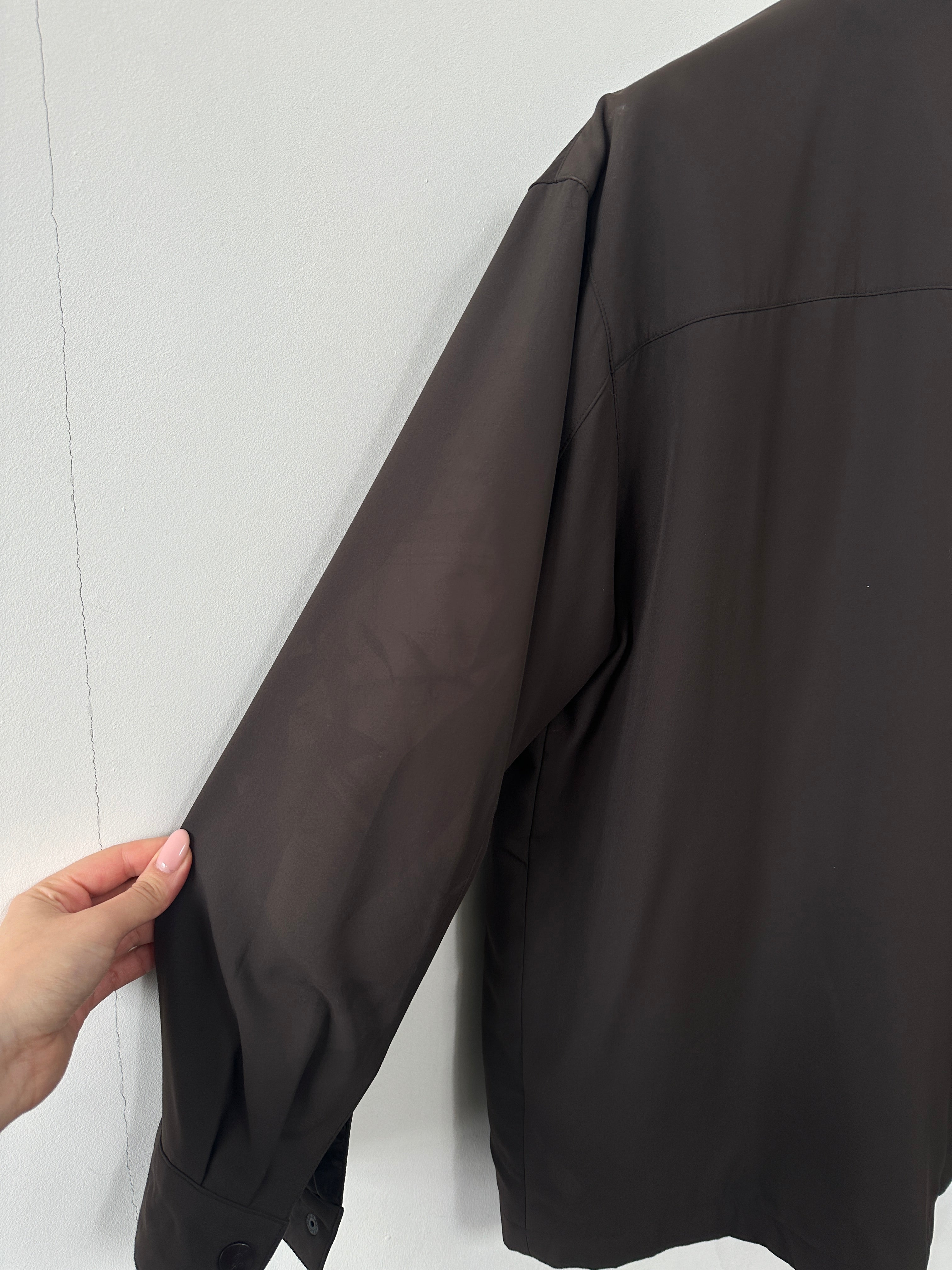 Yves Saint Laurent Pour Homme logo bomber jacket in black, front view showing the signature YSL logo on the chest.