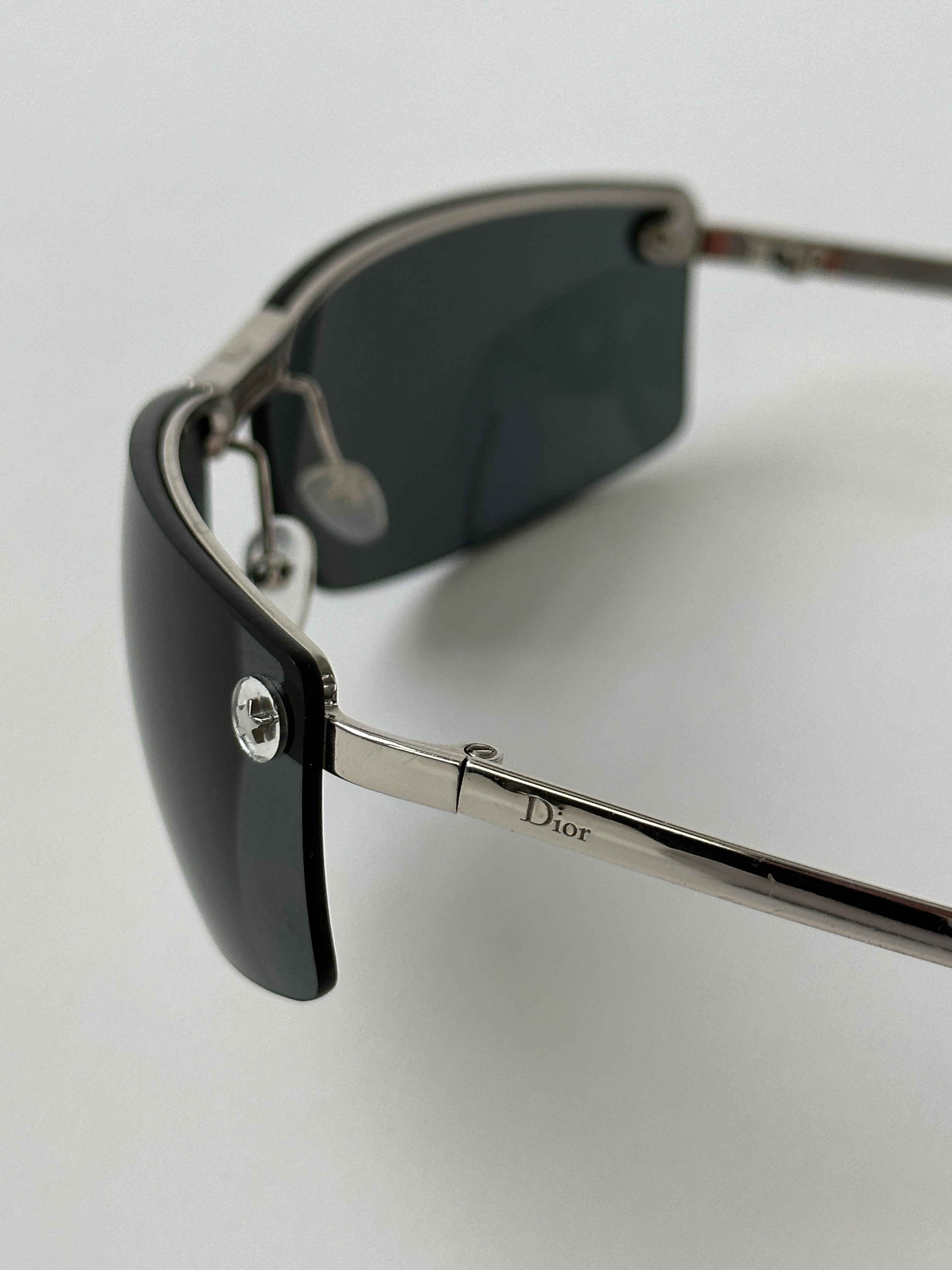 Christian Dior 2000s rimless sunglasses with sleek, minimalist design and tinted lenses, showcasing a stylish eyewear accessory.