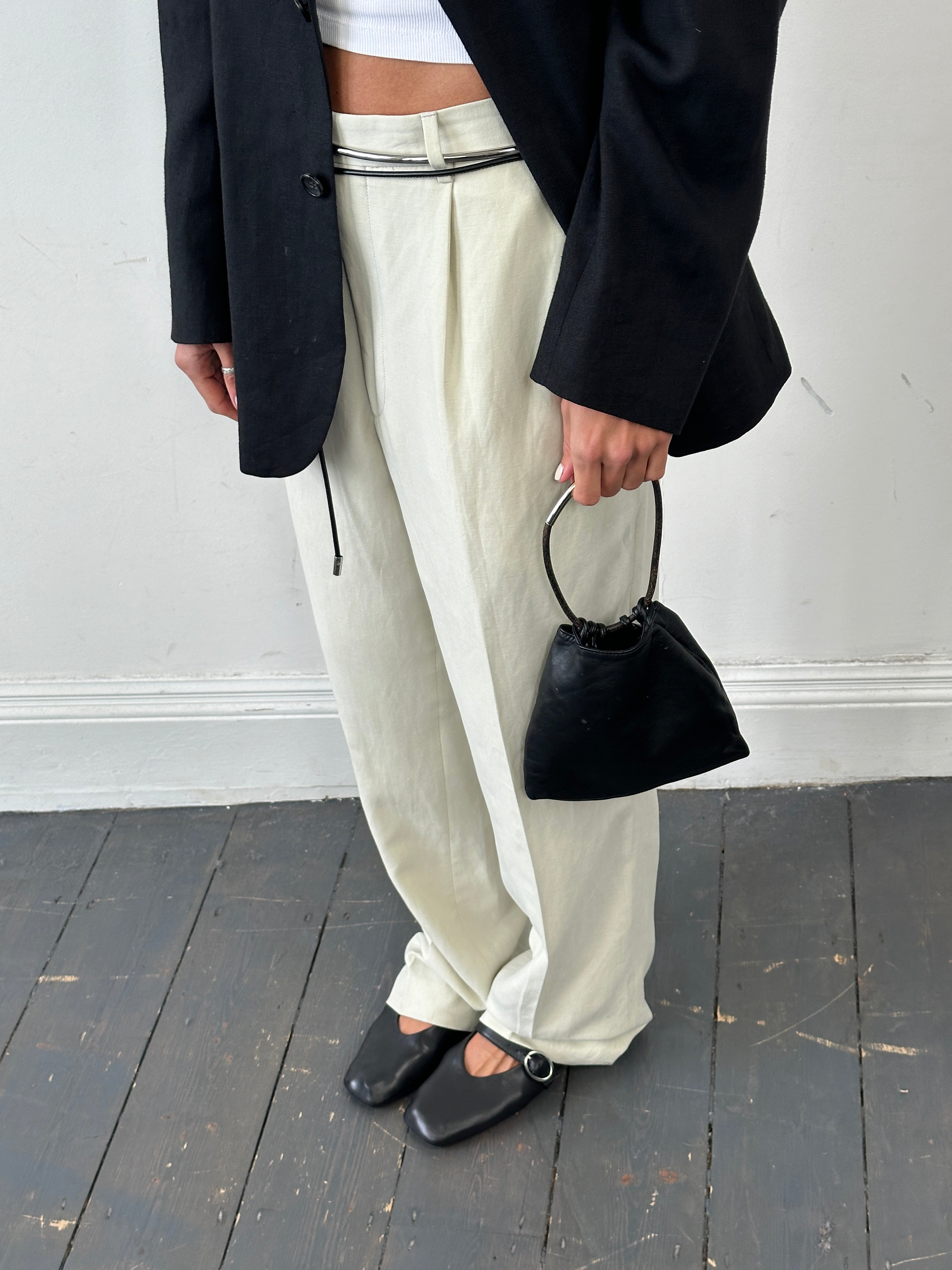 DKNY soft leather clutch bag with sleek design, featuring a fold-over flap and subtle branding, perfect for evening accessories.