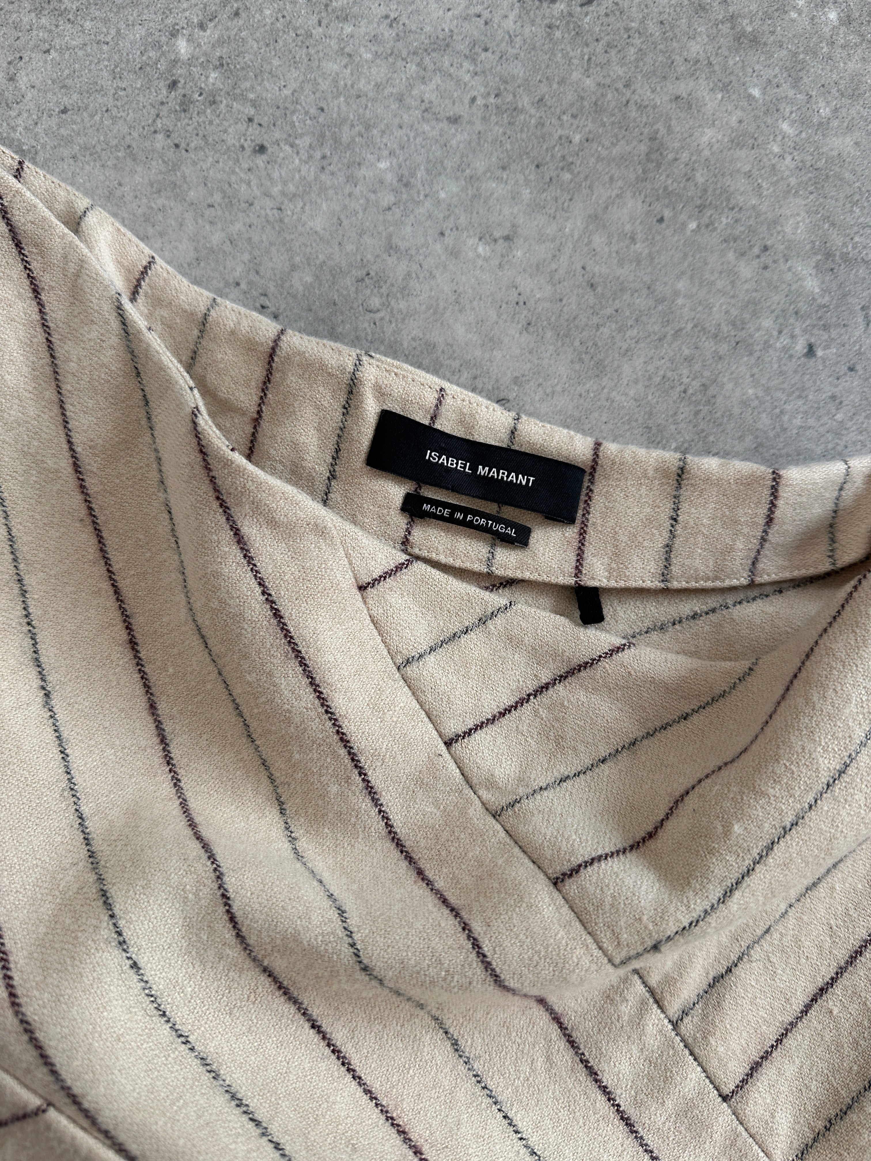 Isabel Marant AW2017 asymmetric layered stripe mini skirt displayed on a hanger, showcasing its unique design and bold pattern.
