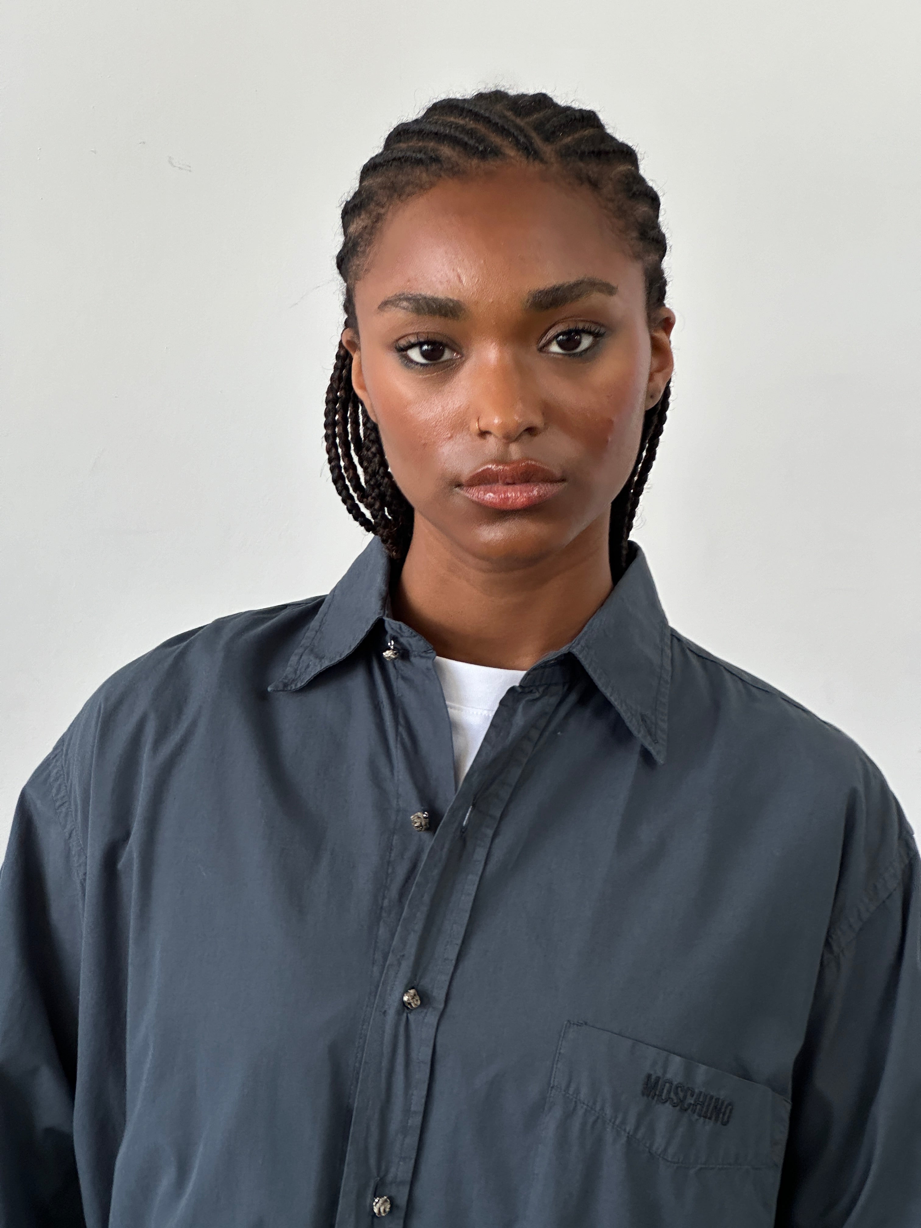 Moschino pure cotton bespoke button logo shirt in size L displayed on a hanger with a classic collar and front button closure.