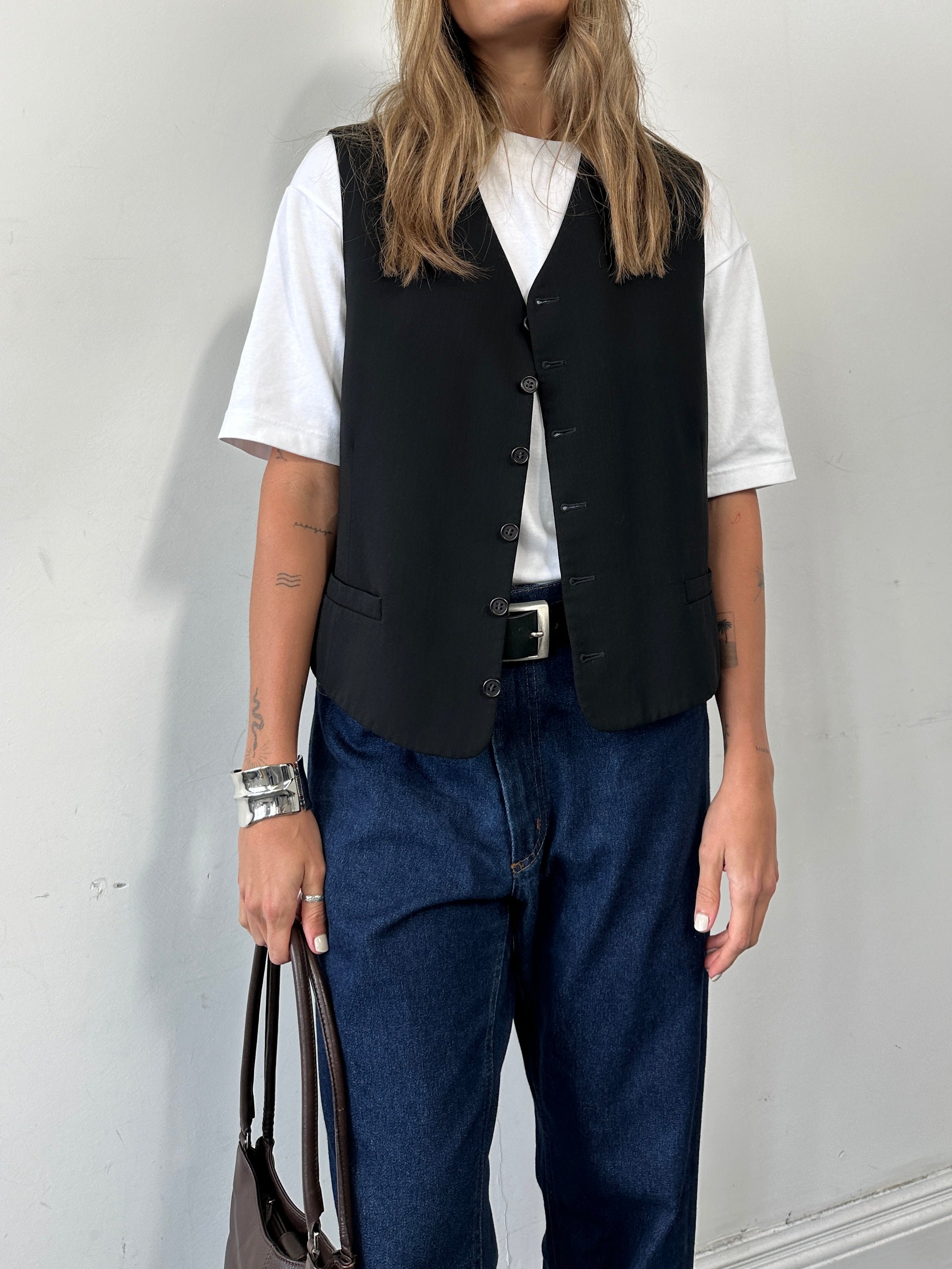 Yves Saint Laurent Pour Homme tailored wool waistcoat in size 42R/L, classic design with a sleek lapel and button closure.