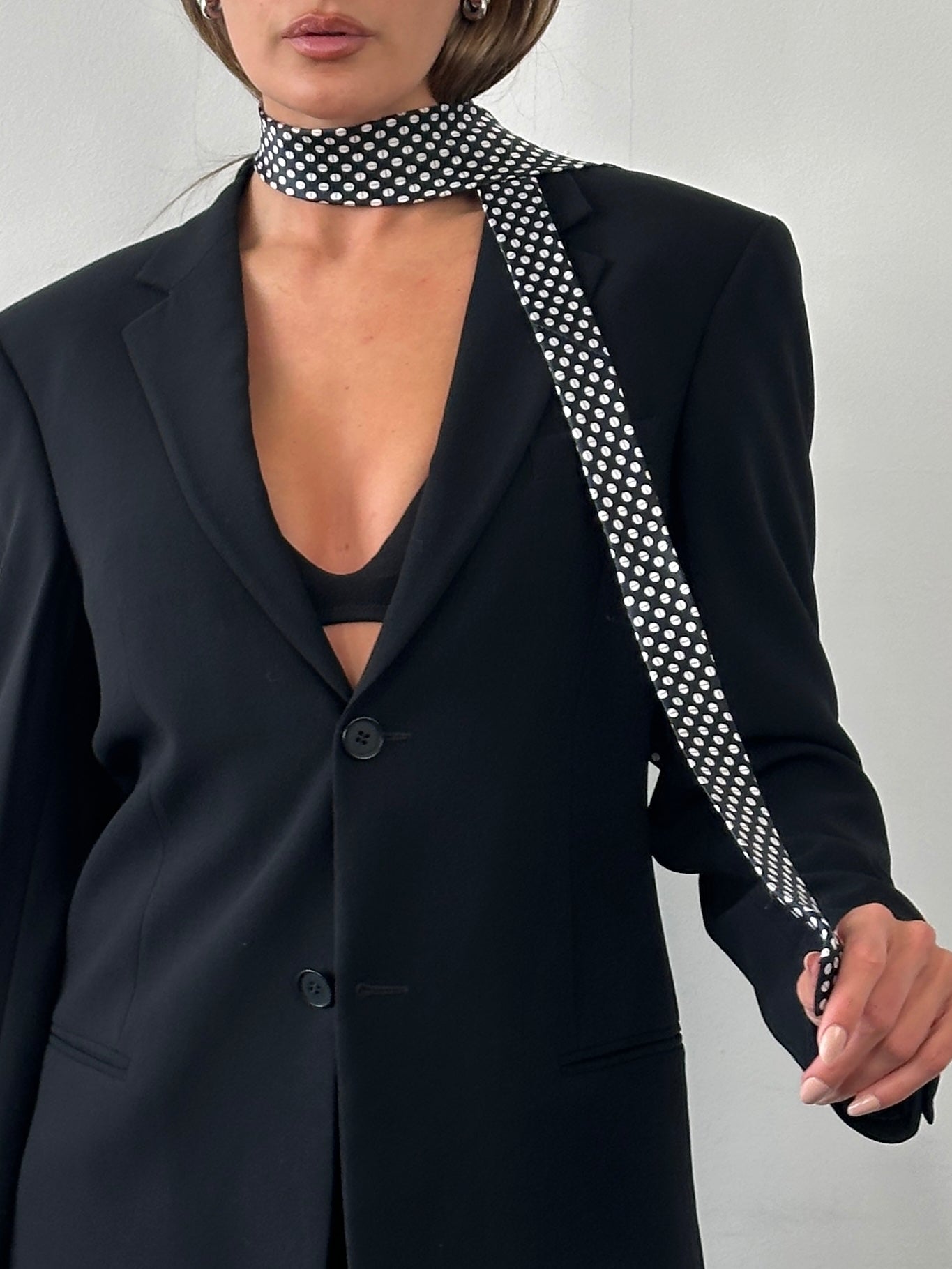 Vintage 1990s pure silk polkadot tie featuring a classic design, with a smooth silk texture and a stylish pattern.
