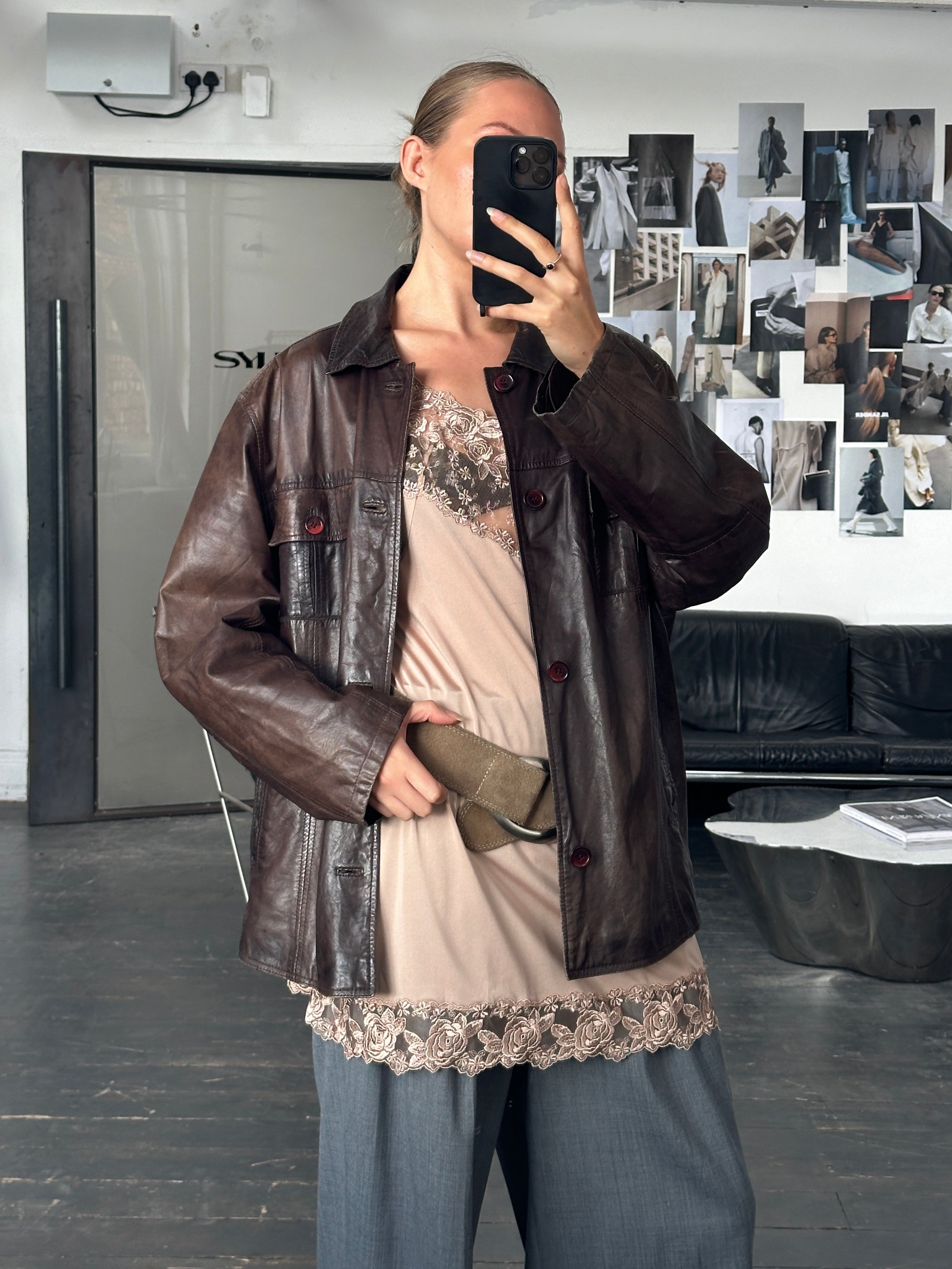 Vintage 1990s aged leather jacket in XL size, showcasing distressed brown leather with classic style and vintage detailing.