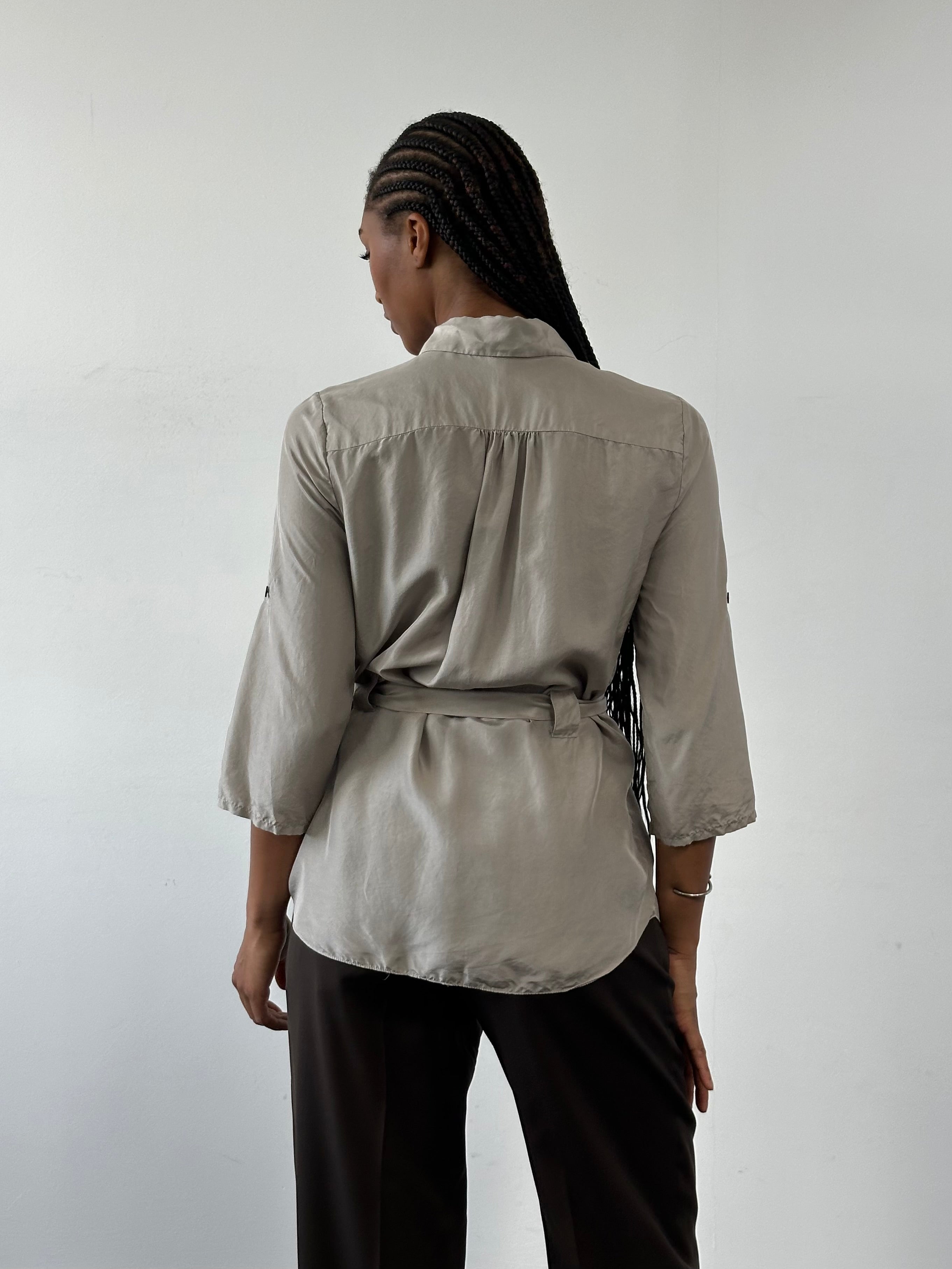 Jaeger pure silk belted shirt in size small, featuring a classic collar and front button closure, displayed on a hanger.