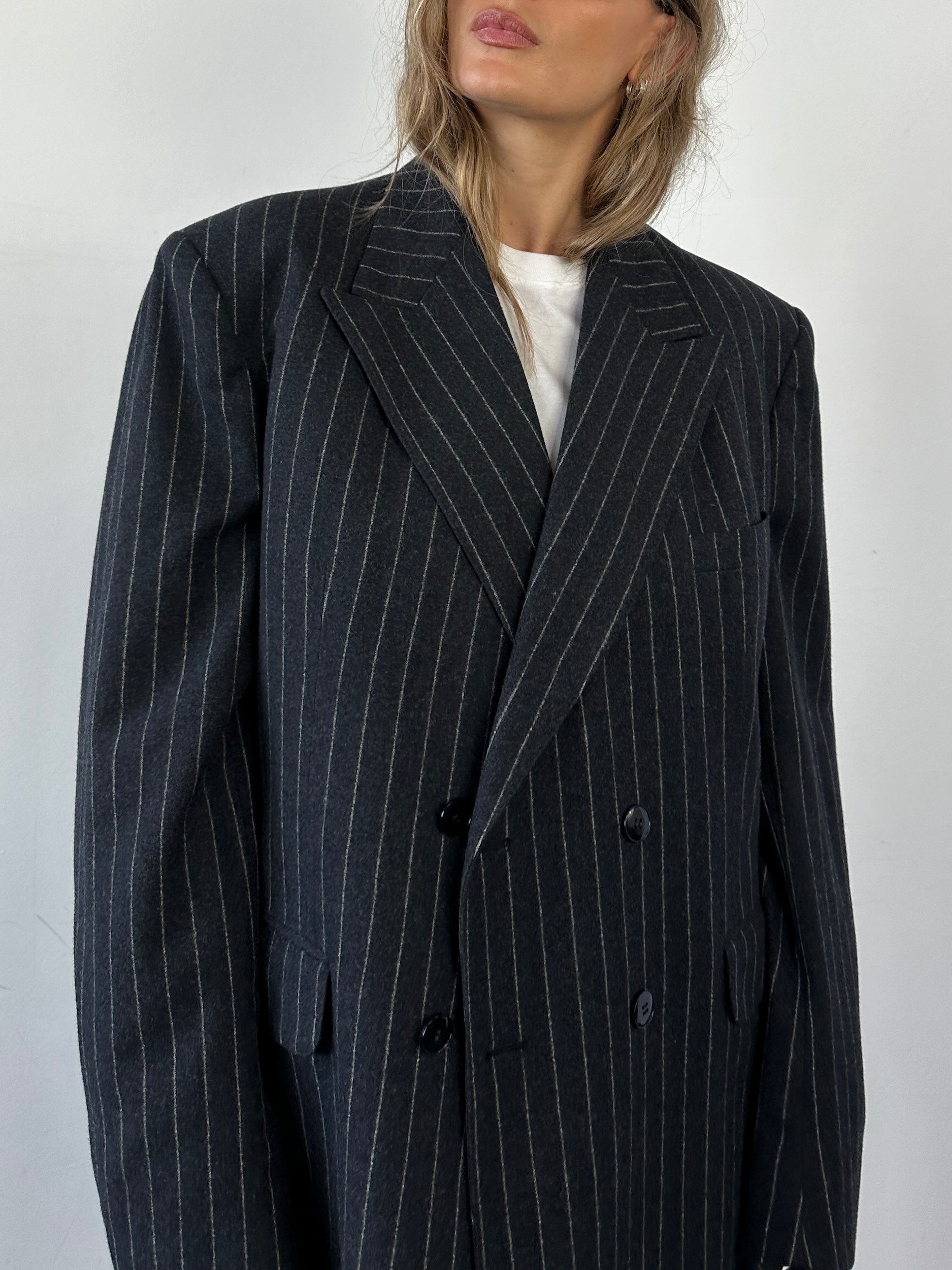 Christian Dior wool double-breasted pinstripe jumpsuit in size 45L/W32, tailored fit with lapel collar and long sleeves.