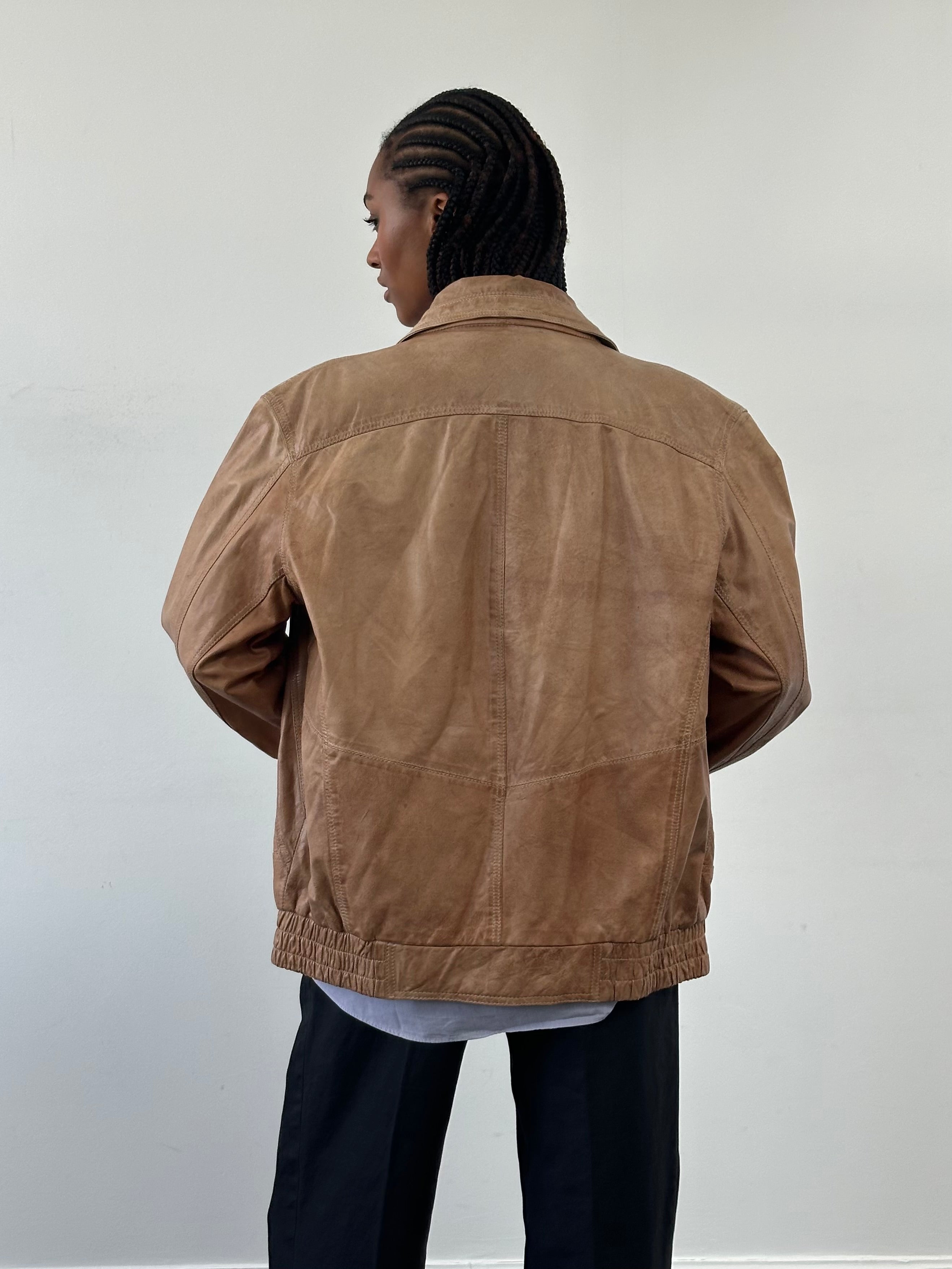Vintage leather bomber jacket from the 1990s, size large, featuring classic style and authentic distressed leather.