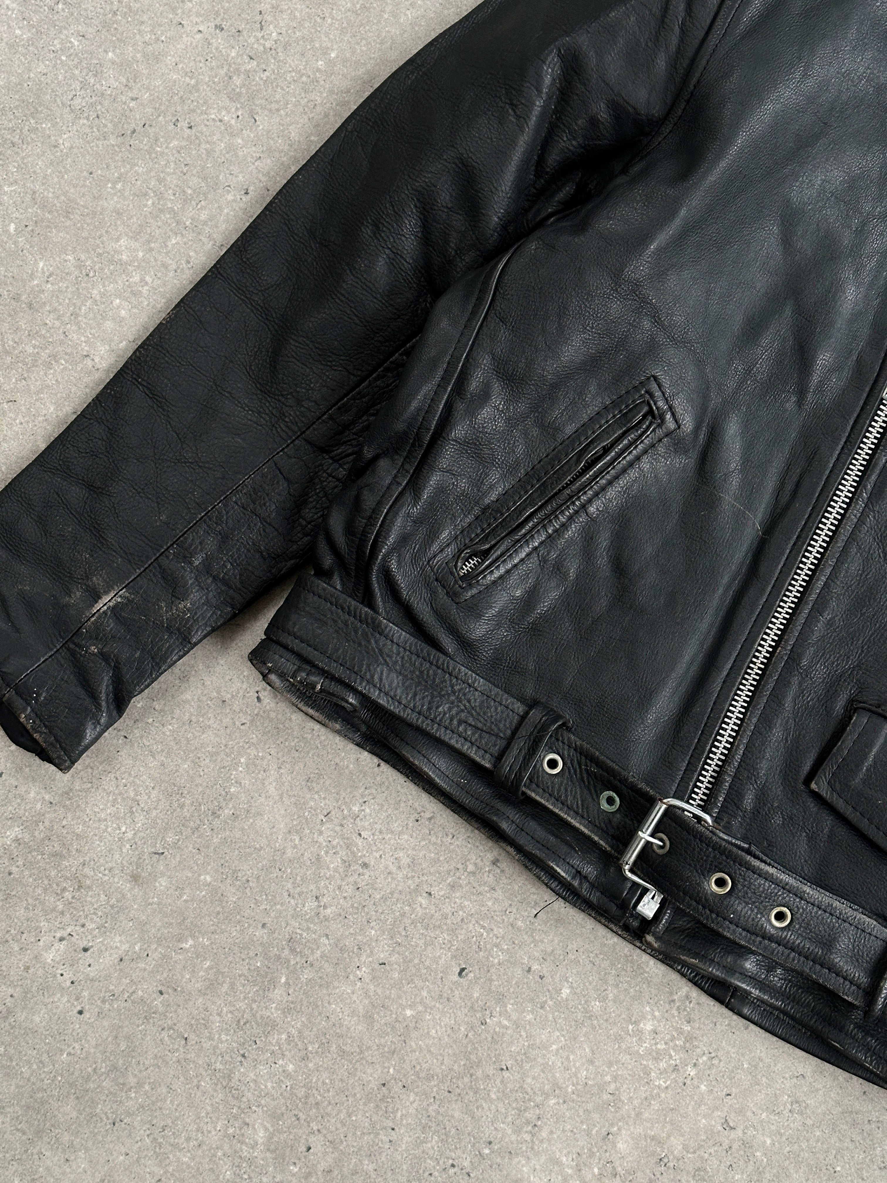 Vintage leather biker jacket in XL size, featuring a classic design with metal zippers and distressed finish.