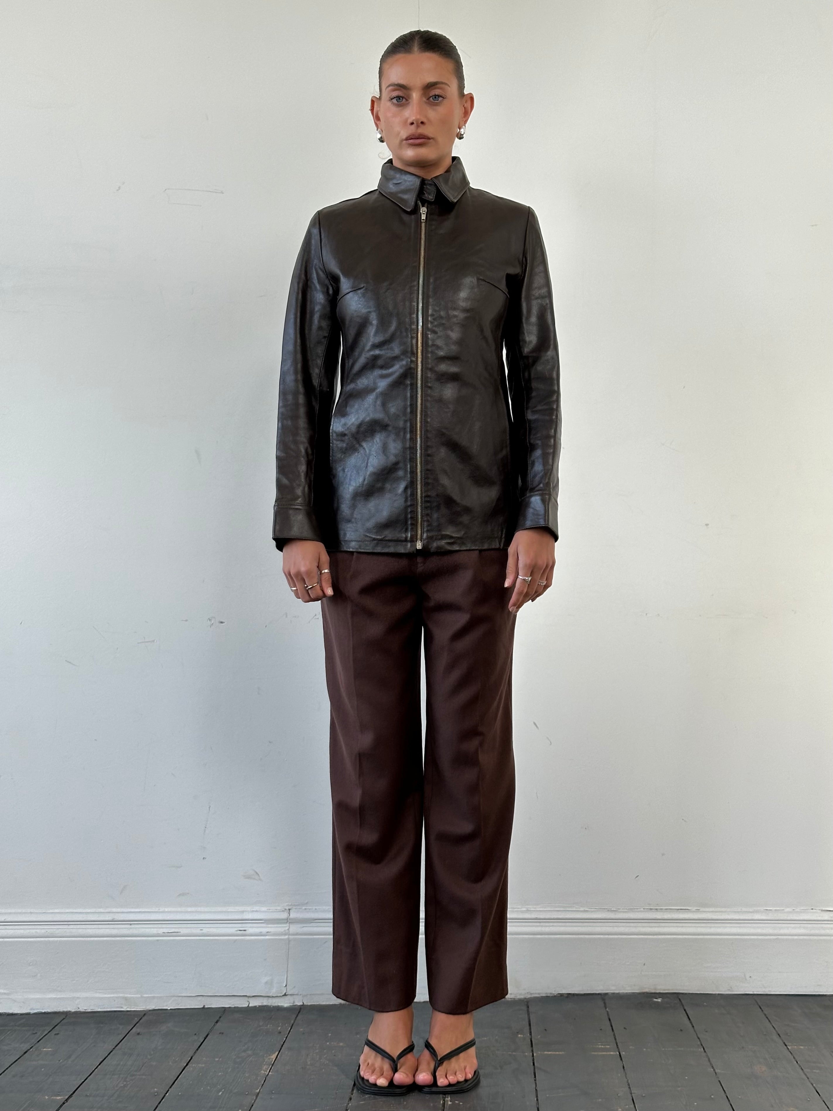Vintage smooth leather jacket in size small, classic design with a sleek finish and detailed stitching.