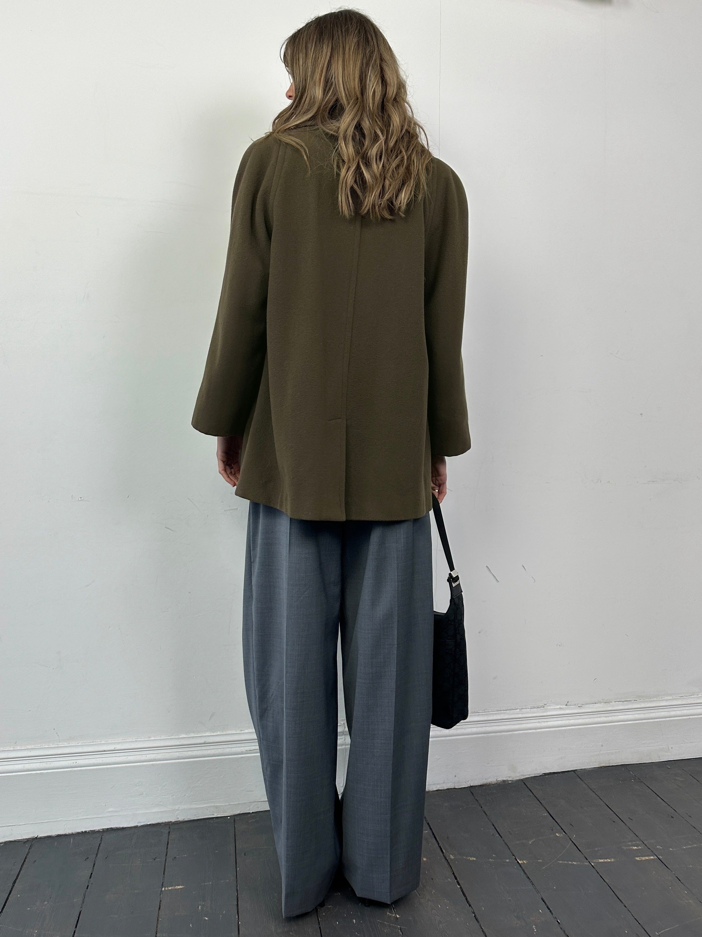 Aquascutum pure new wool coat in size M, showcasing a stylish tailored design with classic collar and button details.
