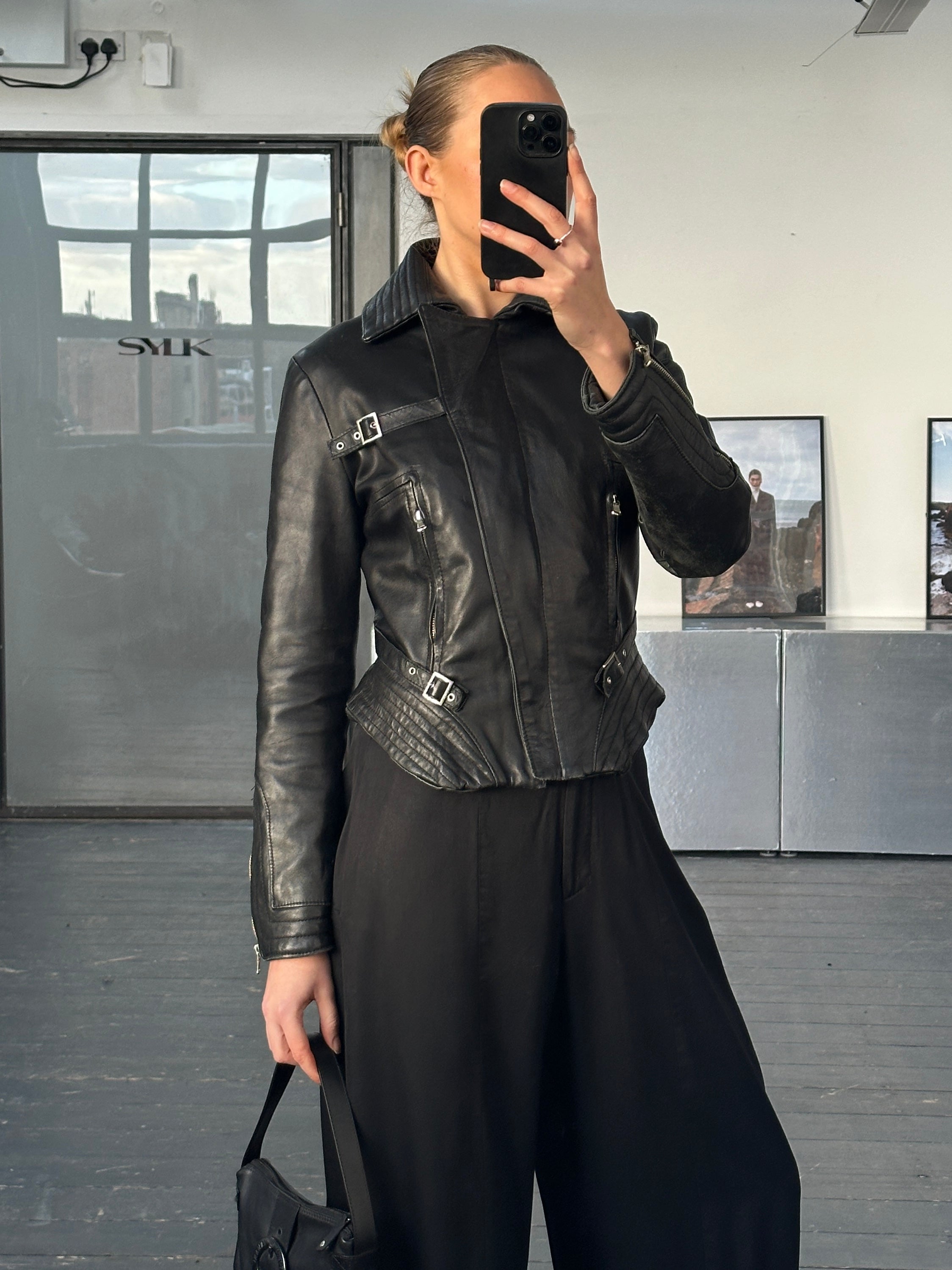 Vintage Italian 1990s fitted leather jacket with buckled details, crafted from high-quality leather in a classic design.