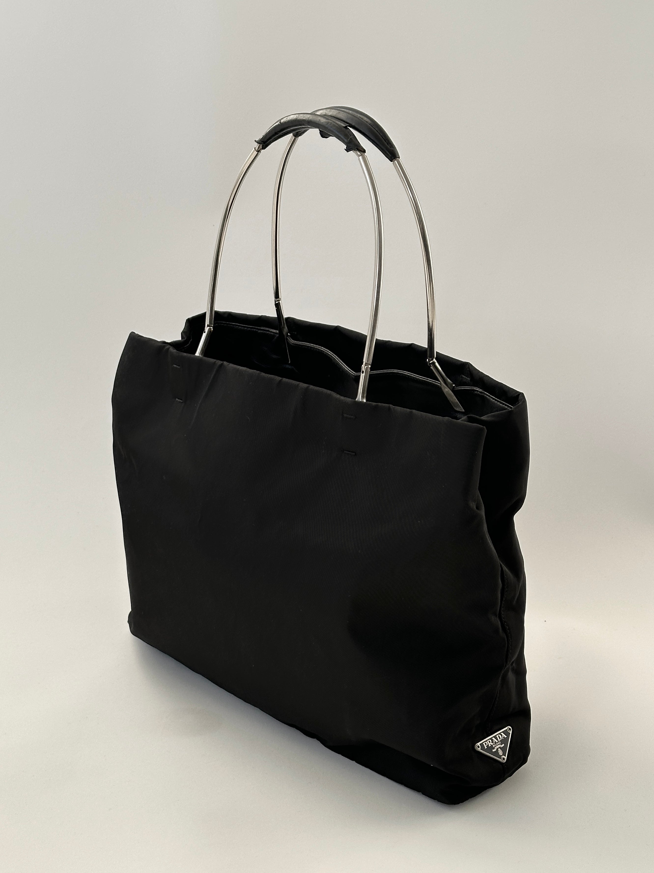 Prada nylon leather tote bag with sleek design, sturdy handles, and spacious interior, perfect for everyday use and style.