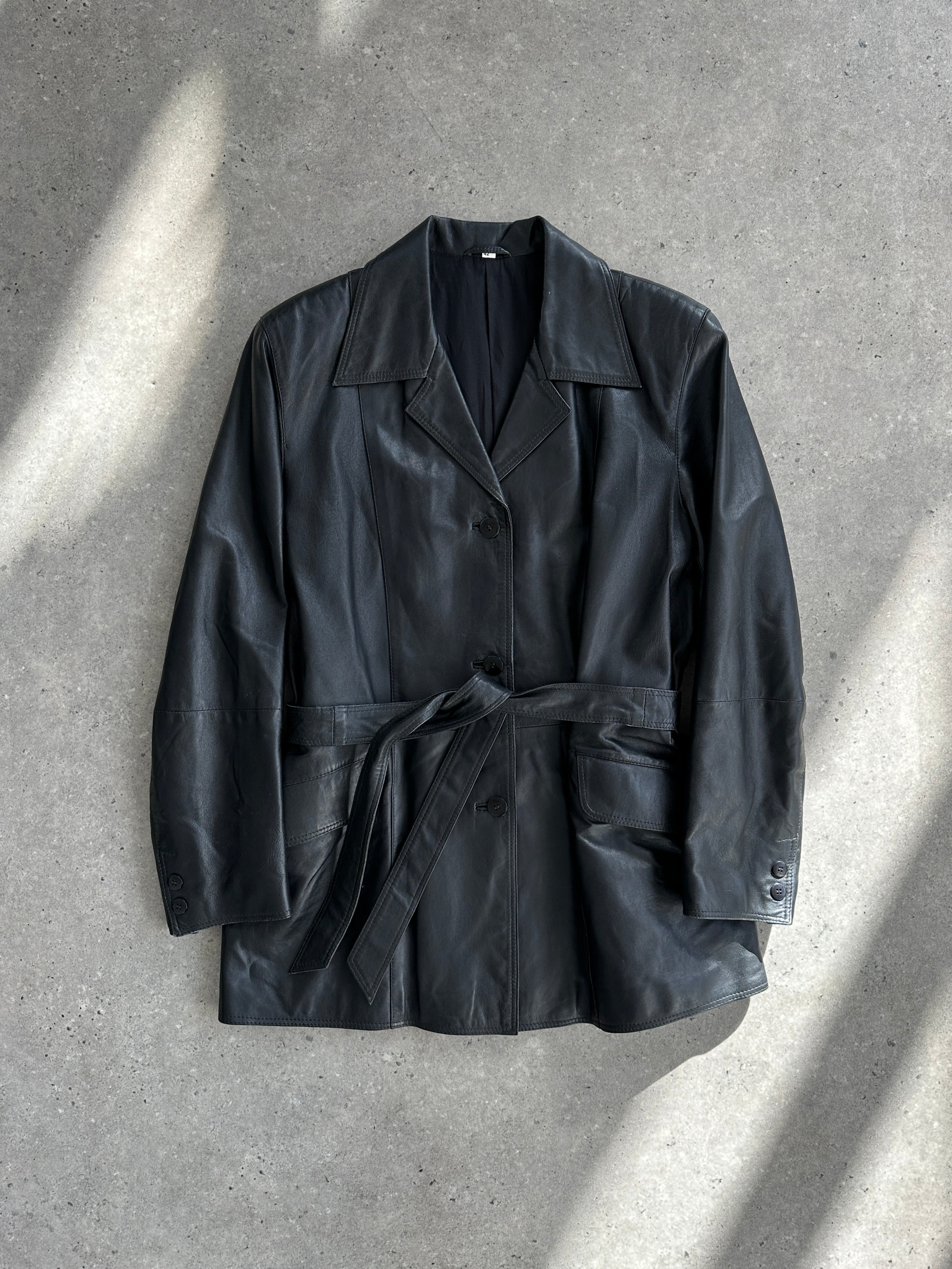Conbipel belted leather jacket in size M, shown in black, featuring a classic collar, front zipper, and waist belt.