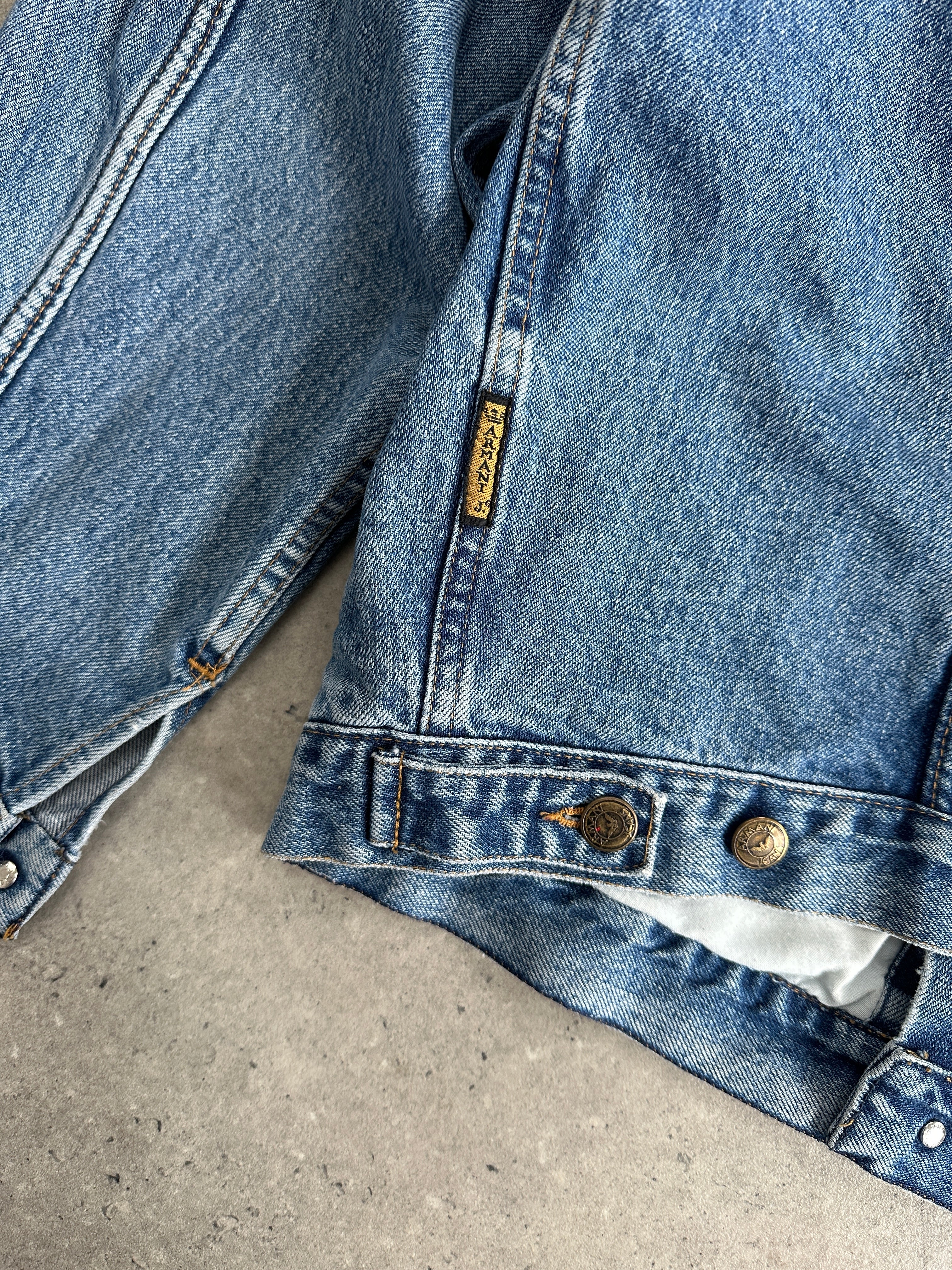 Armani Jeans mid wash denim jacket in size L, featuring classic collar and button-front design, displayed on a hanger.
