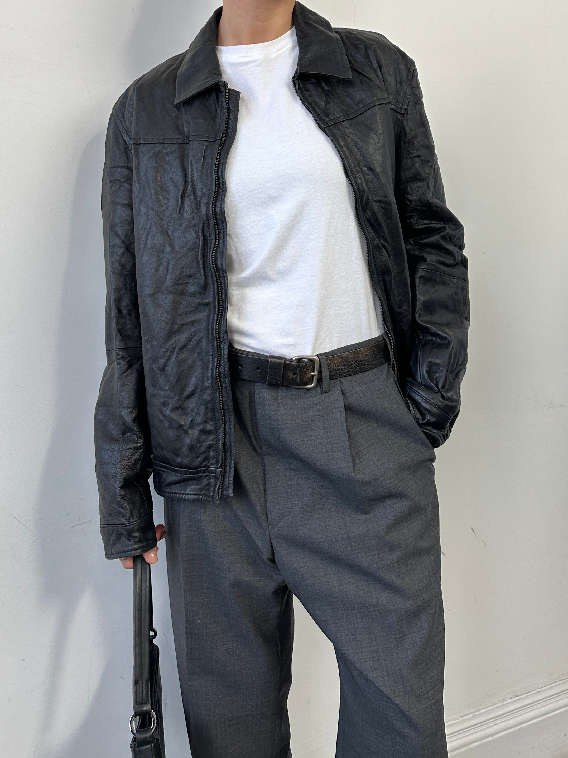 Vintage men's zip-up leather jacket, size M, featuring classic design and high-quality leather with detailed stitching.