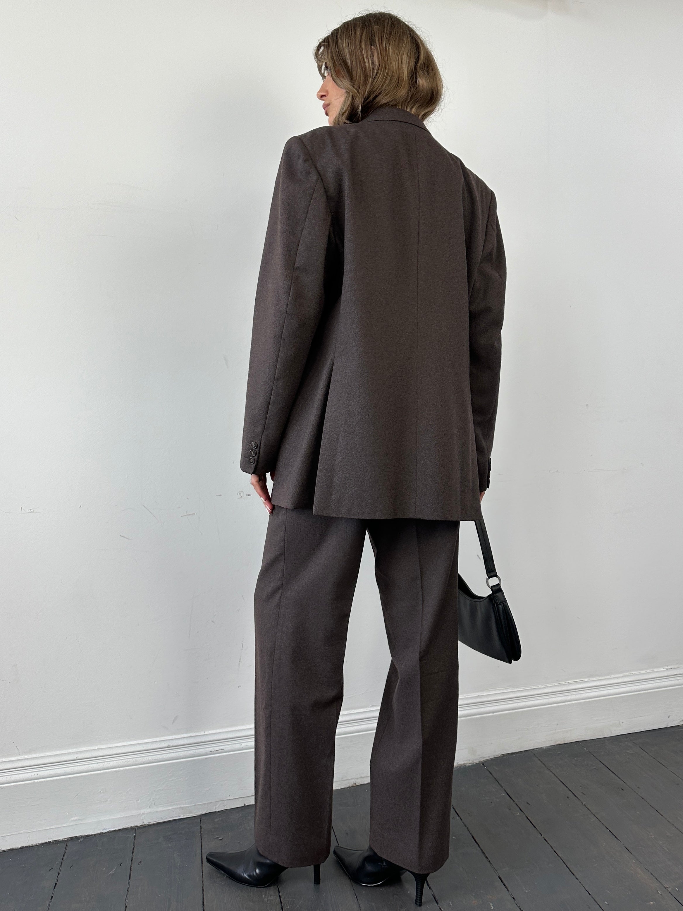 Christian Dior pure wool jumpsuit in size 46R/W34, tailored fit with classic lapel collar and full-length sleeves.