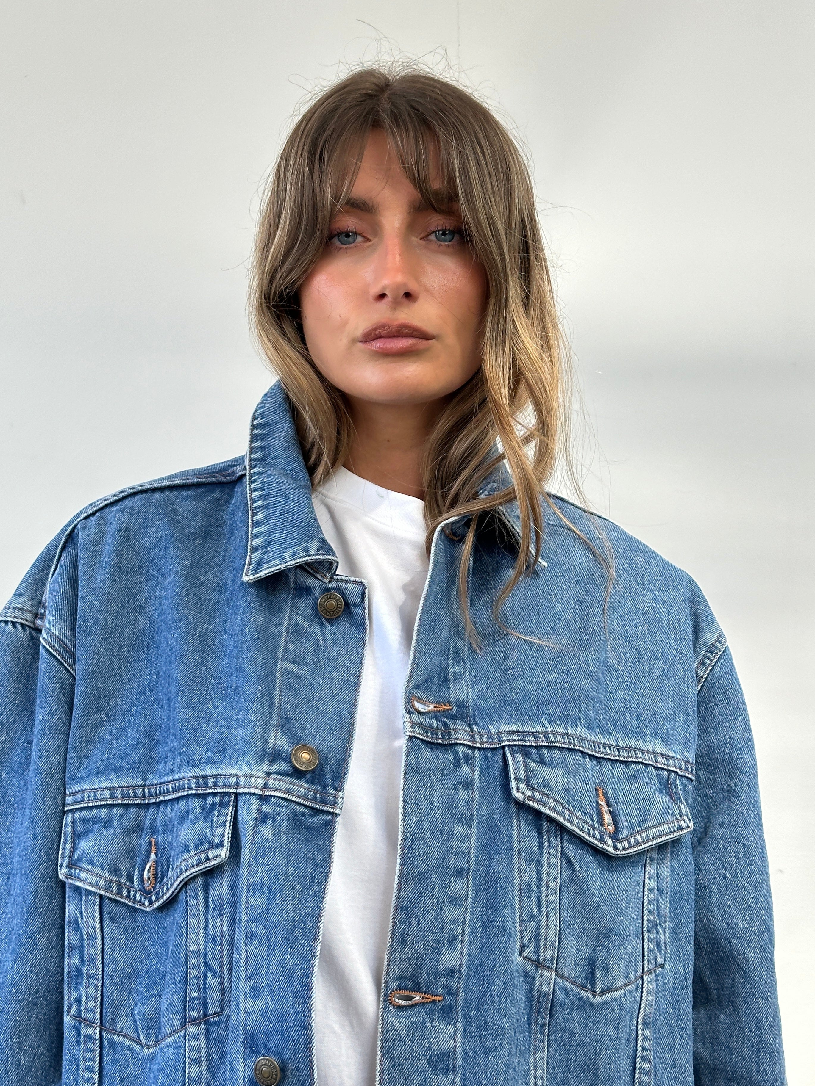 Vintage oversized pure cotton denim jacket in XL, featuring classic blue denim fabric and traditional collar detail.