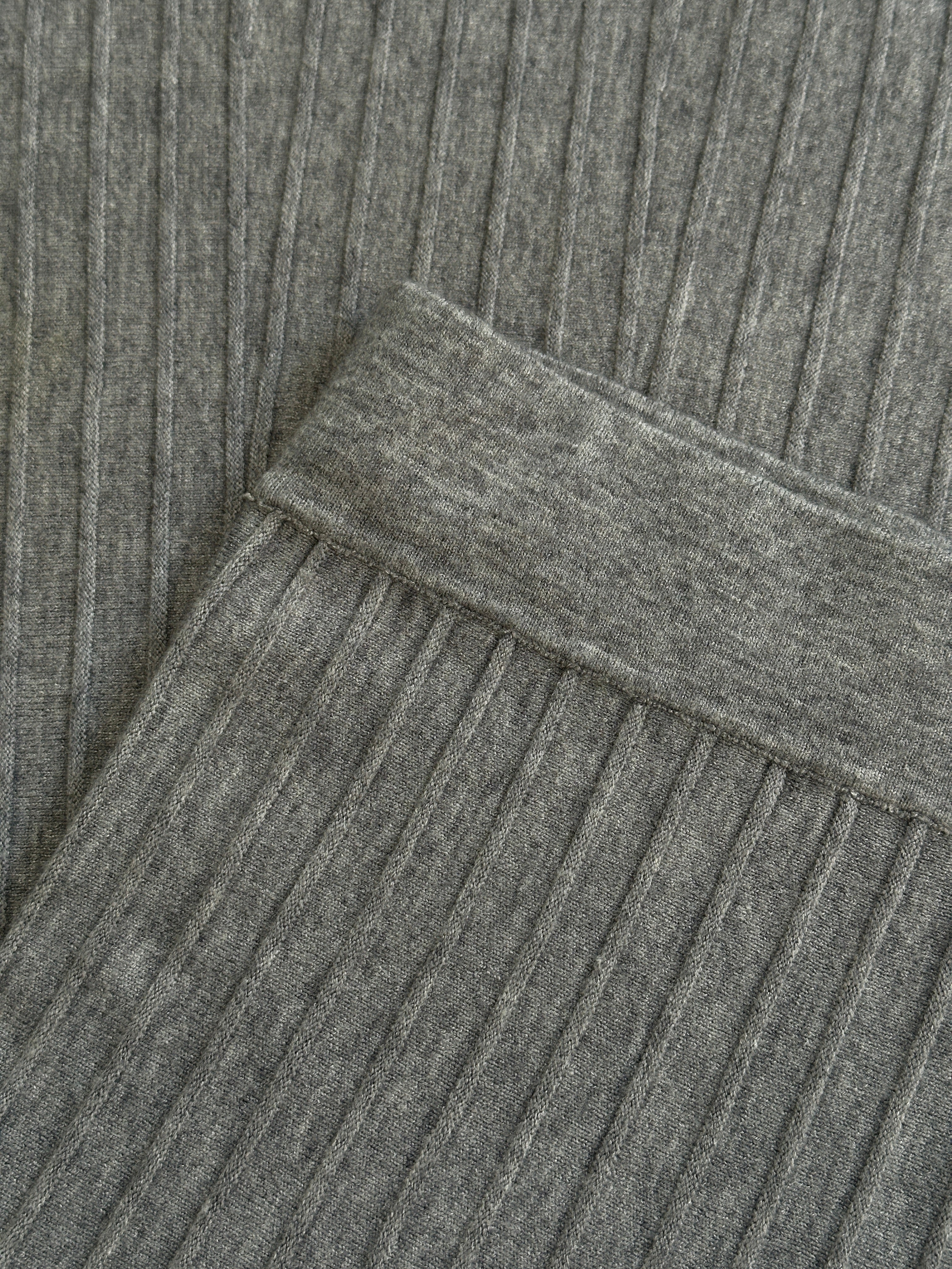 Vintage ribbed elasticated midi skirt in neutral tones, shown on a hanger with a close-up of the textured fabric.