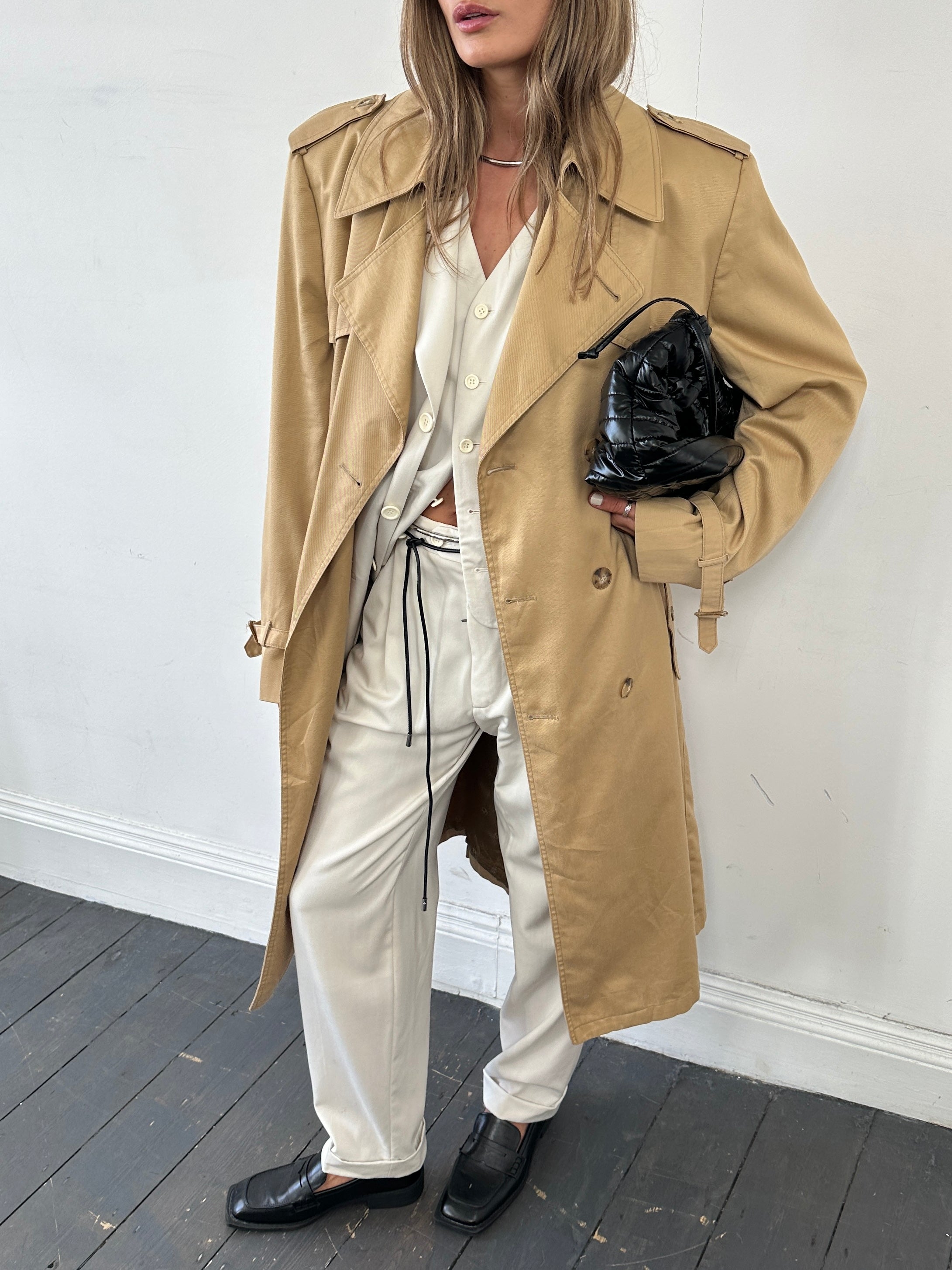 Christian Dior cotton double-breasted trench coat in size L/XL displayed on a hanger with classic design and belt details.
