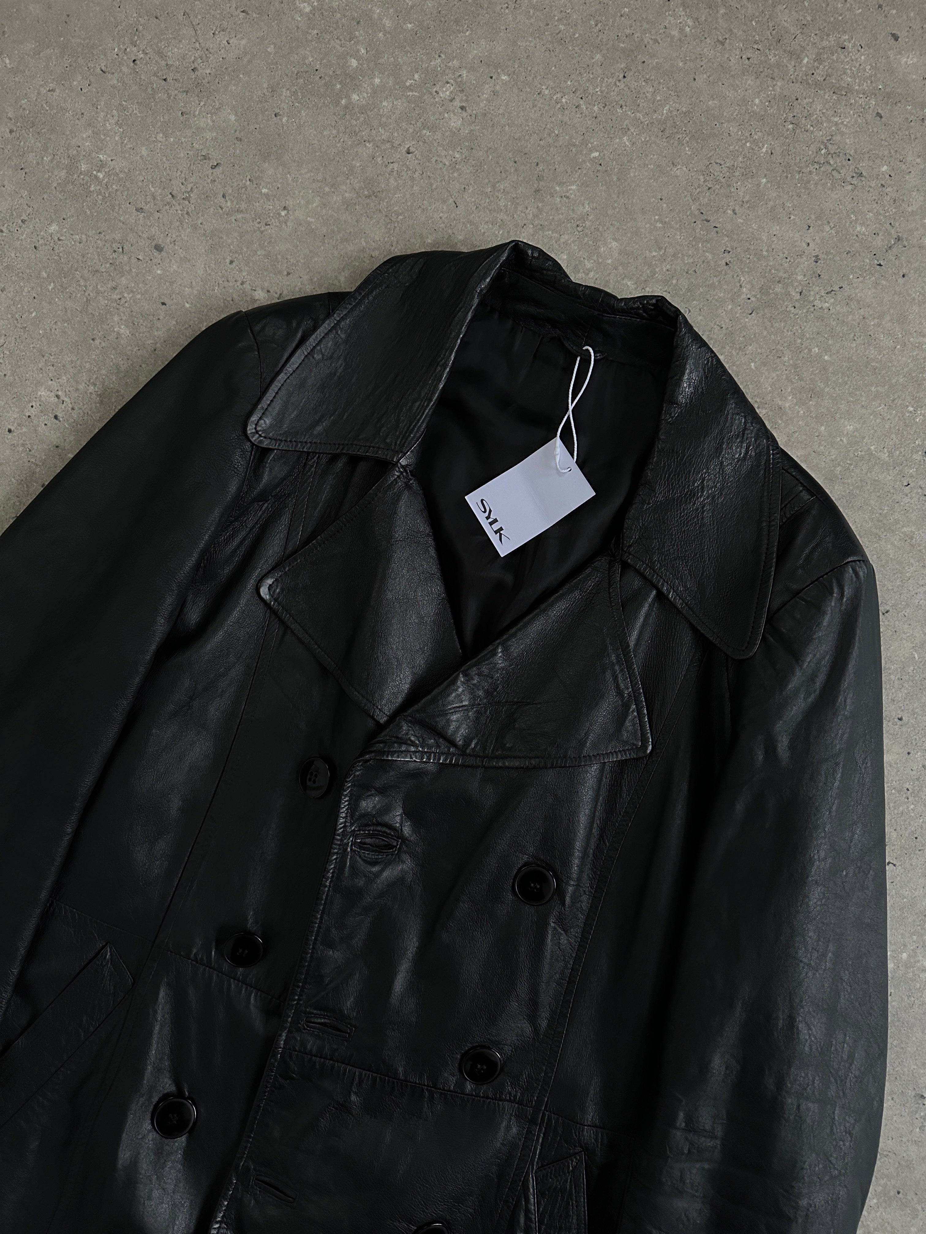 Vintage Italian double-breasted mid-length leather jacket in classic style, displayed on a hanger with visible button details.