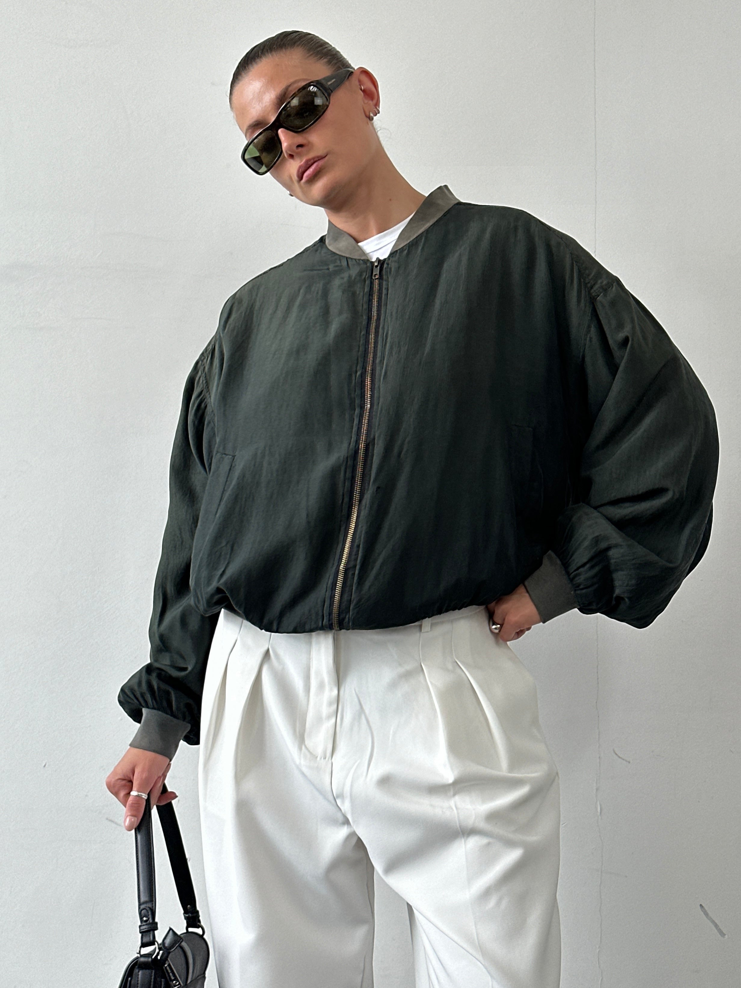 Vintage Pure Silk Bomber Jacket in size L, featuring a smooth, shiny fabric and classic bomber style with ribbed cuffs and collar.