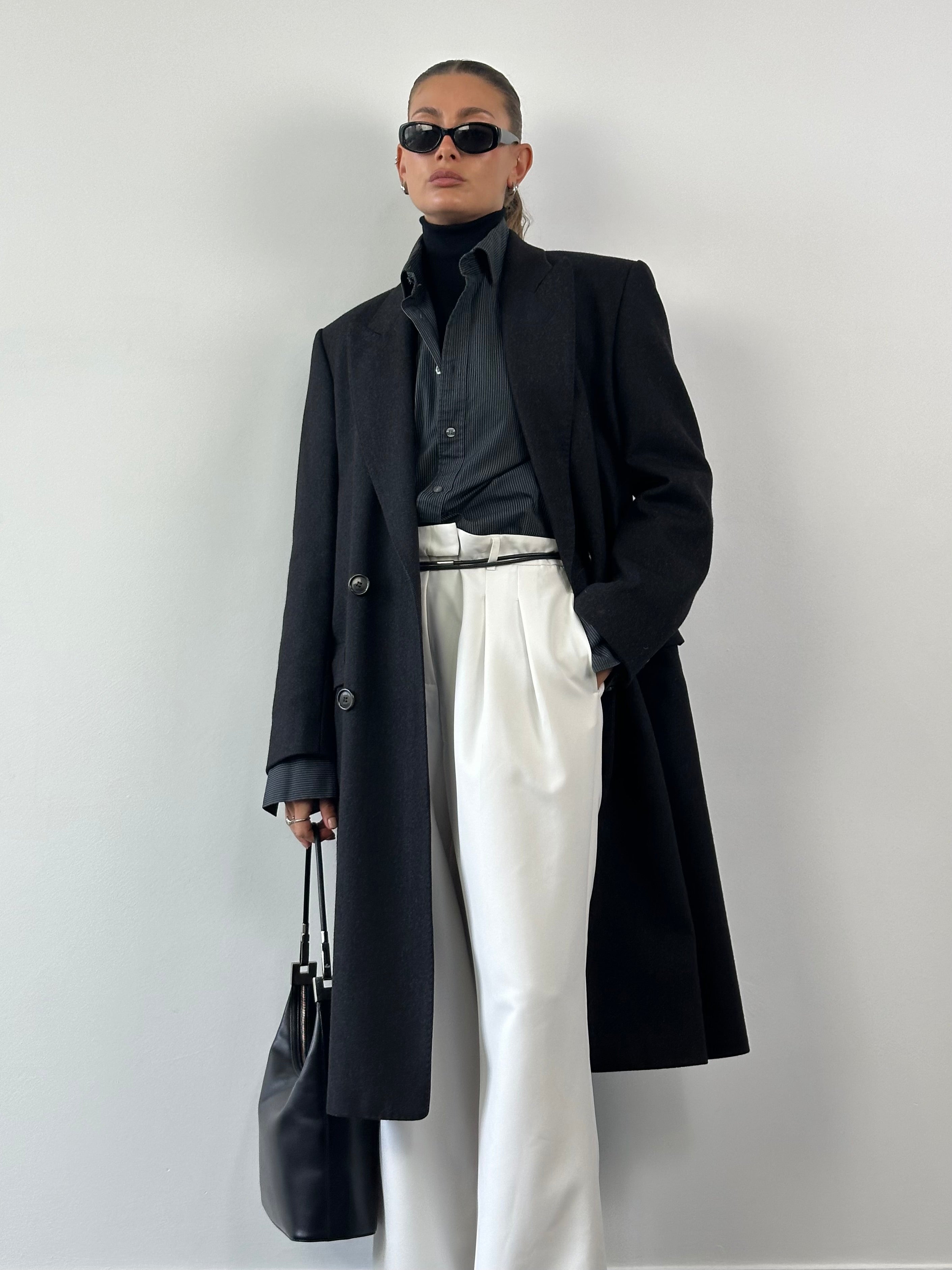 Christian Dior pure wool double-breasted coat in size L/XL, shown on model, featuring classic tailored design and elegant lapels.