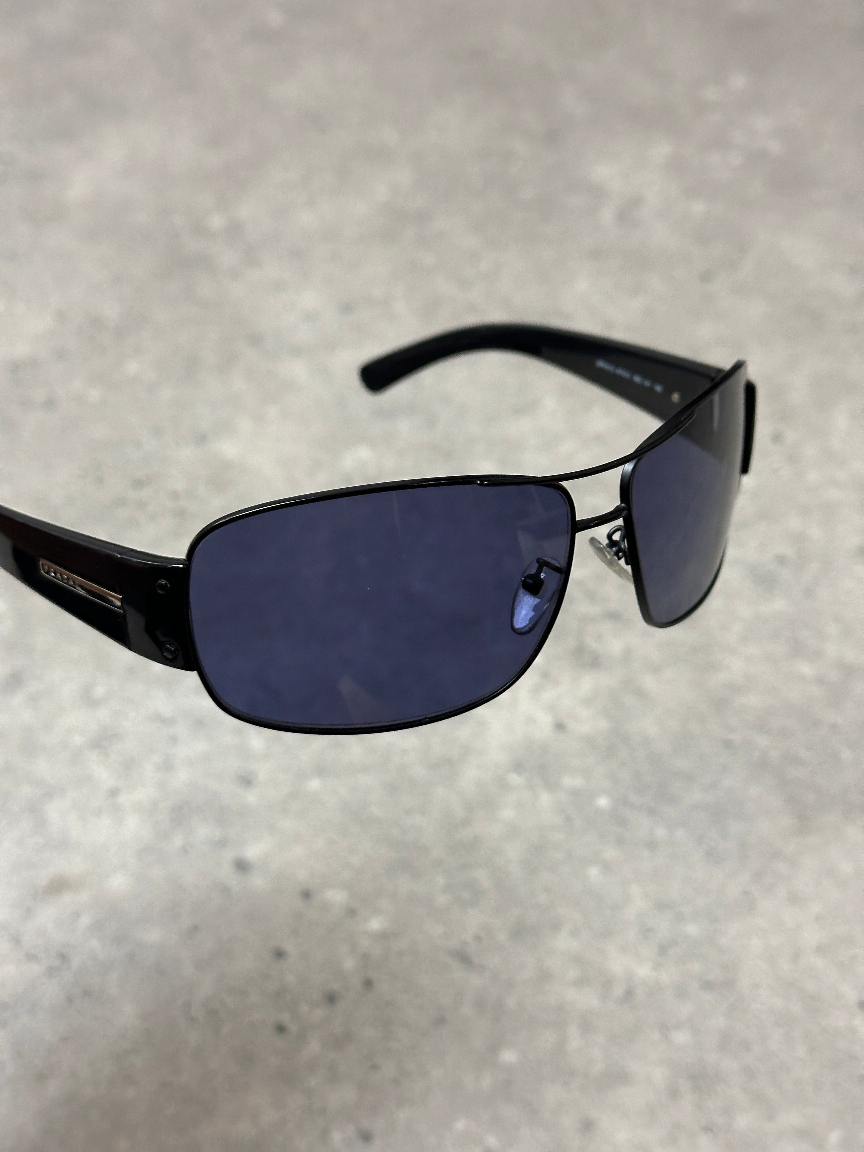 Prada aviator shield sunglasses with dark tinted lenses and metal frame, stylish eyewear for sun protection.