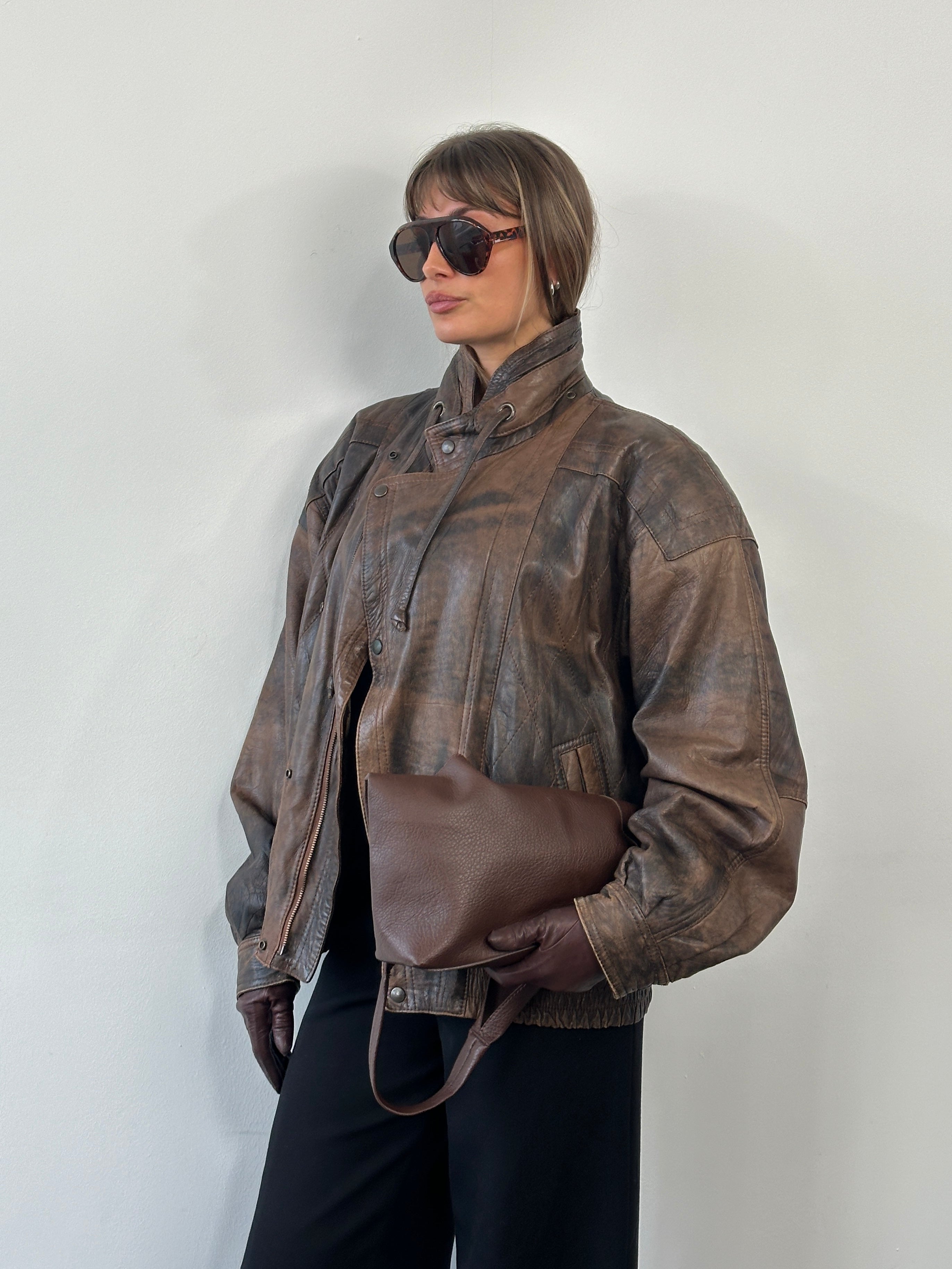 Vintage 1990s high neck leather bomber jacket in aged leather, size XL, showcasing classic vintage style and detailed stitching.