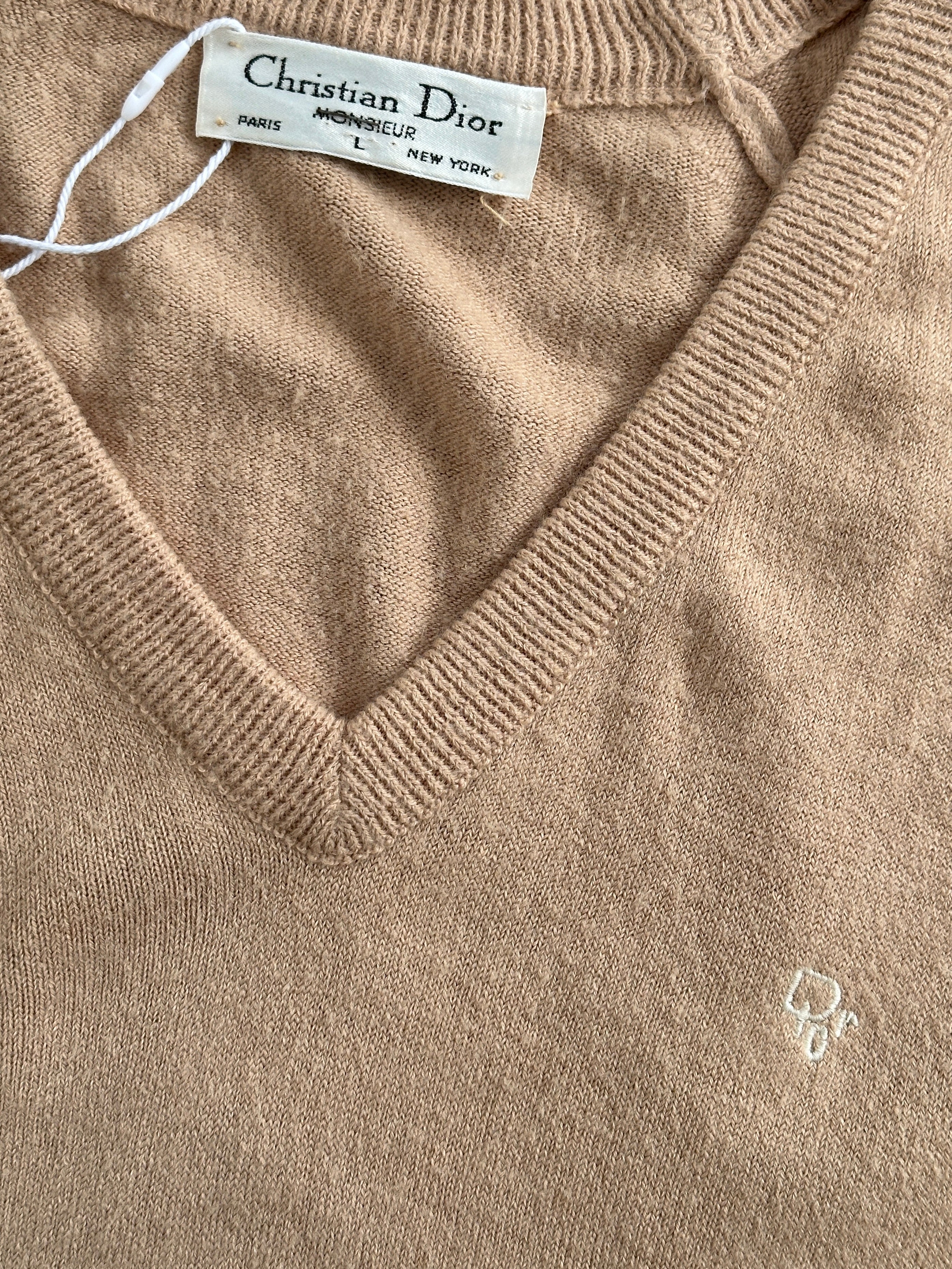 Christian Dior 1980s V-neck logo knitted jumper in light color, featuring the iconic Dior logo and ribbed knit details.