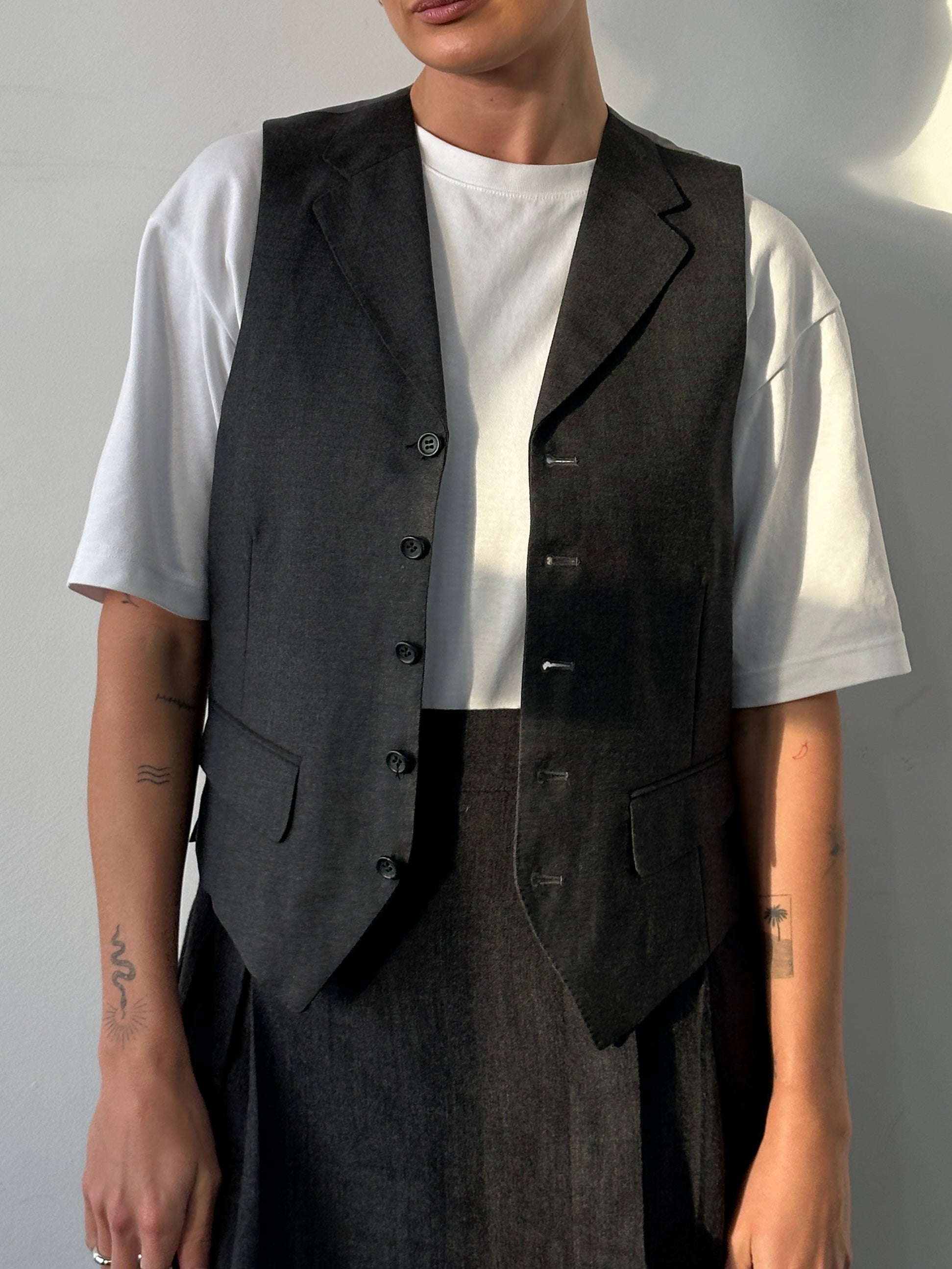 Vintage brand vintage wool waistcoat with a classic collar, front buttons, and tailored fit, displayed on a hanger.