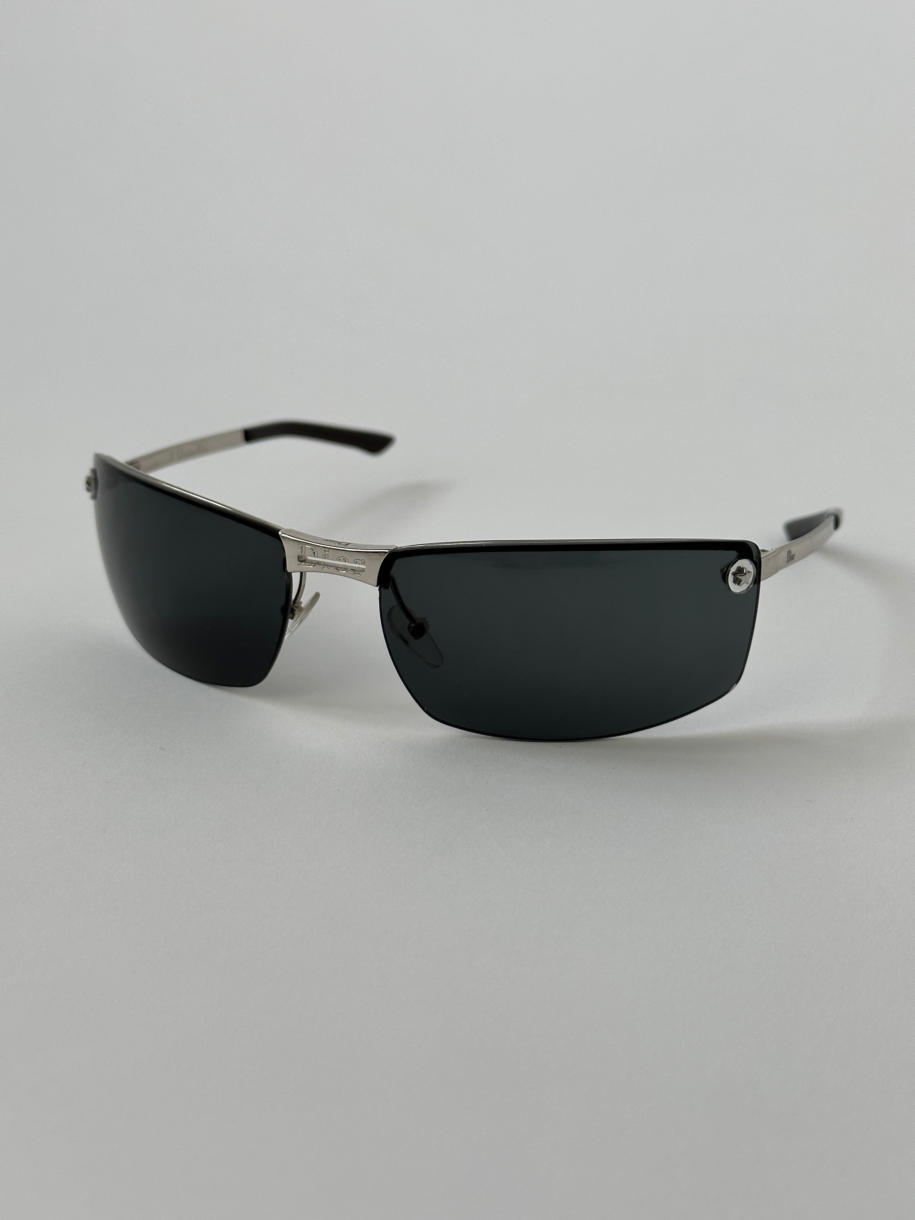 Christian Dior 2000s rimless sunglasses with sleek design and tinted lenses, showcasing a modern, minimalist style.